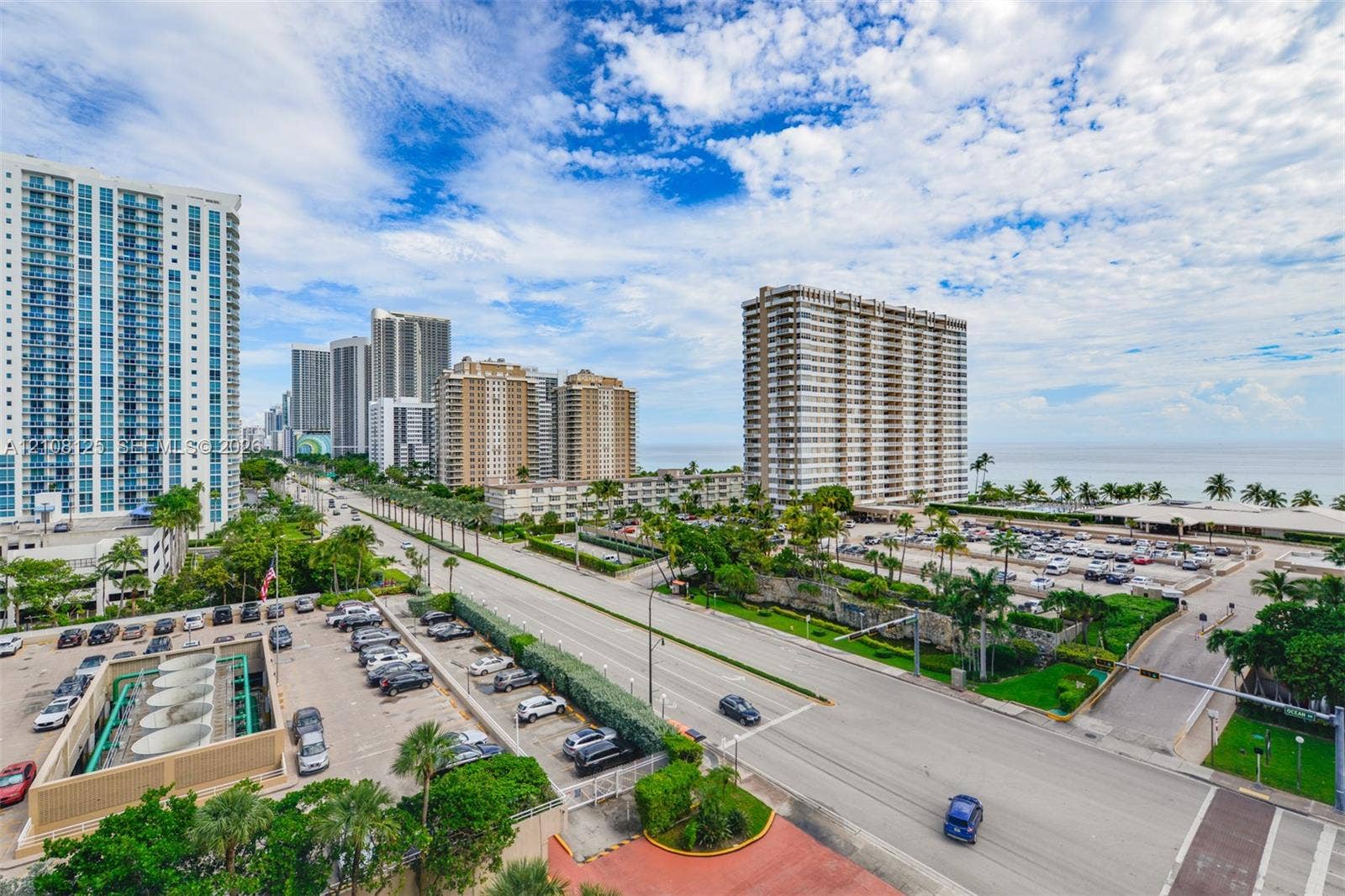 1985 S Ocean Drive, #8M, Hallandale Beach, FL 33009 Aerial perspective of a coastal corridor featuring high-rise architecture, multi-lane roadways, mature palm trees, and proximity to the oceanfront