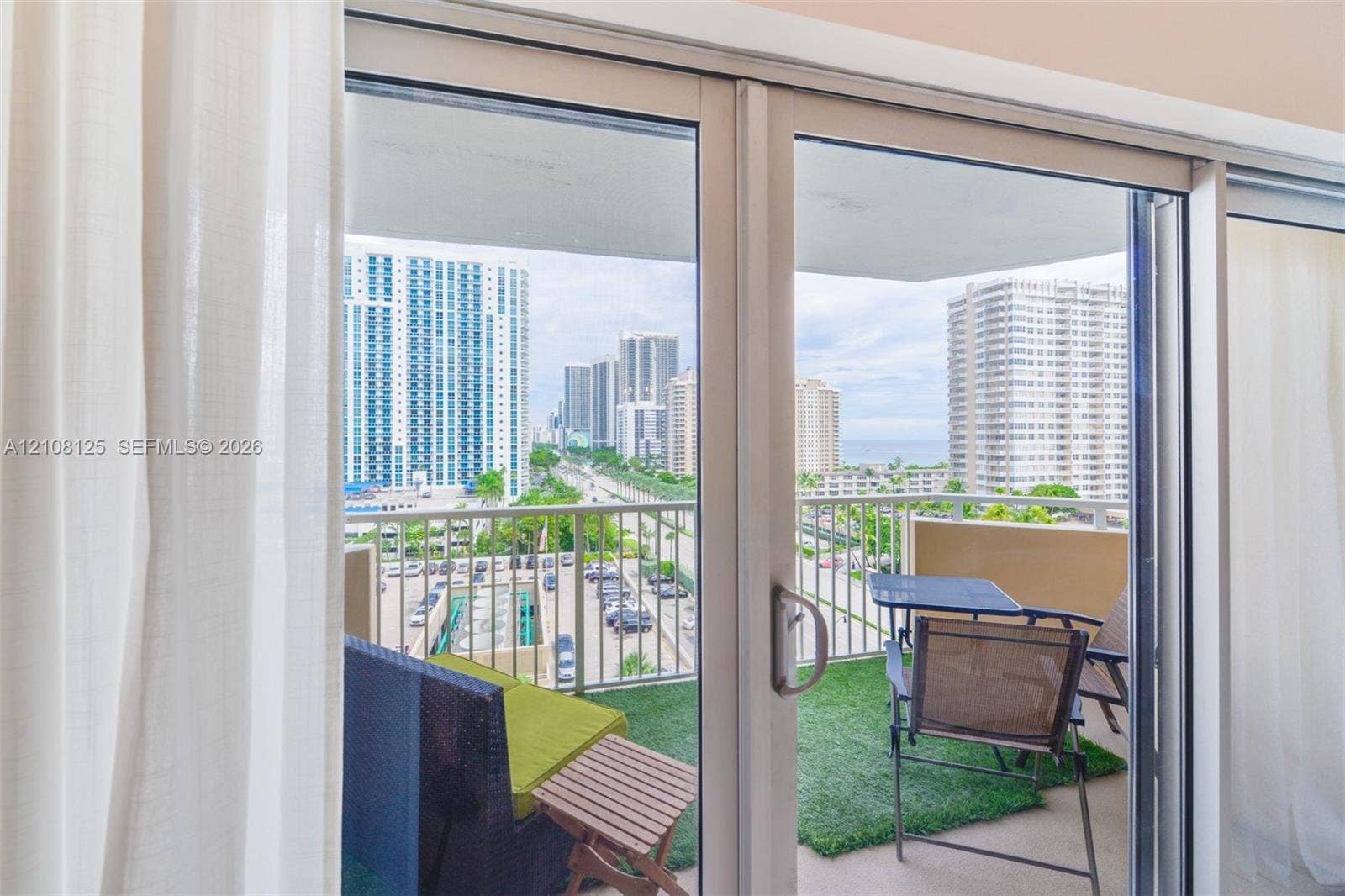 1985 S Ocean Drive, #8M, Hallandale Beach, FL 33009 Floor-to-ceiling sliding glass door opening to a private balcony with metal railings
