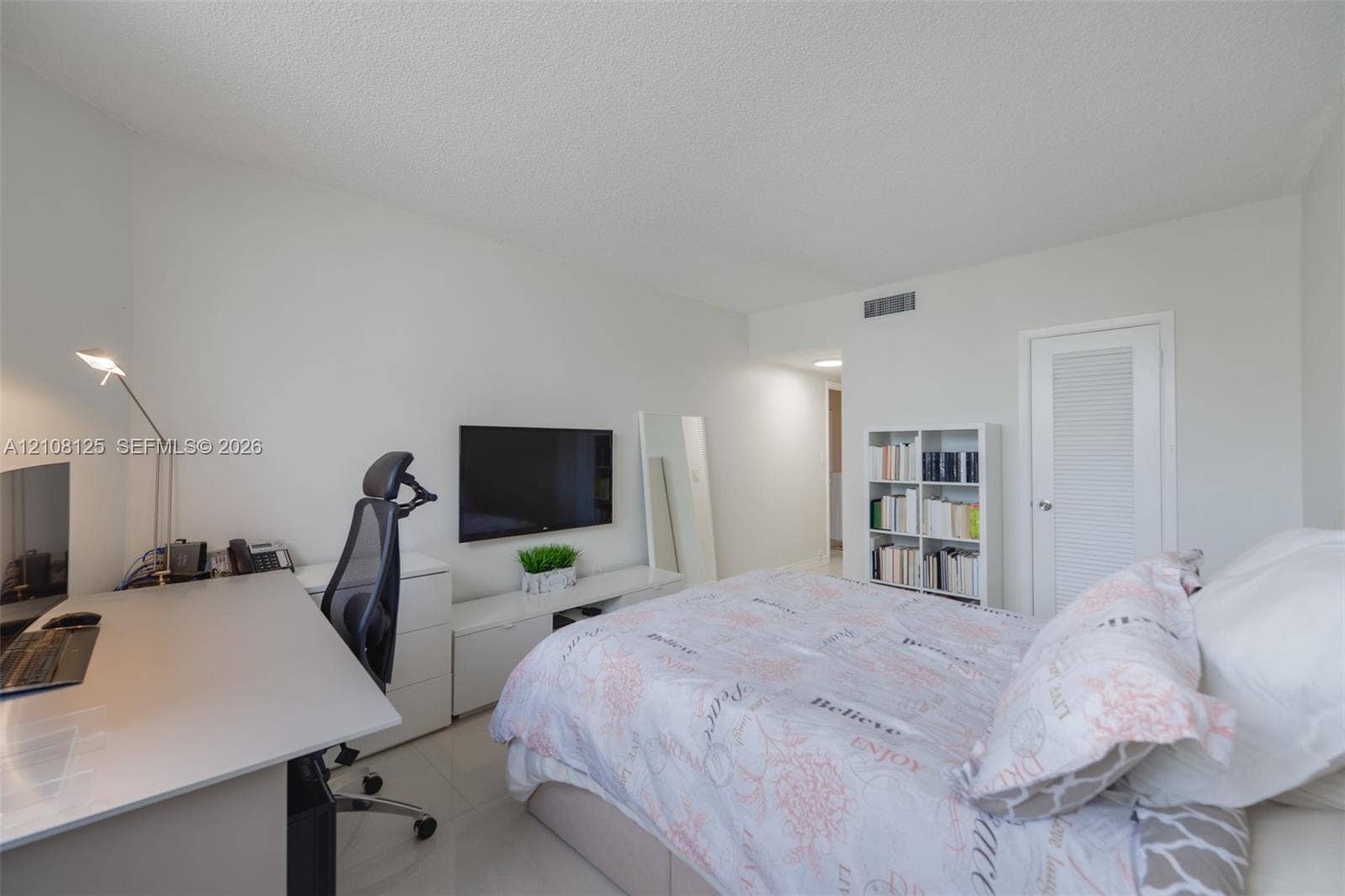 1985 S Ocean Drive, #8M, Hallandale Beach, FL 33009 Neutral interior room featuring white walls, tile flooring, and a single-panel door with a louvered detail