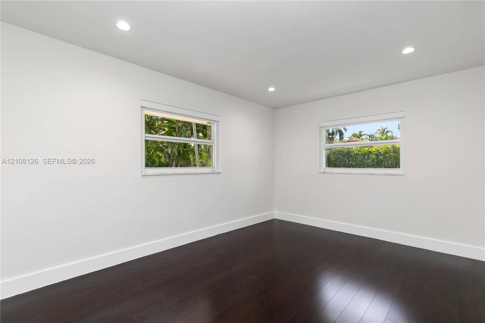 11700 NW 4th Street, Plantation, Plantation, FL 33325 Interior room featuring dark wood-finish flooring, crisp white walls, and recessed ceiling lighting