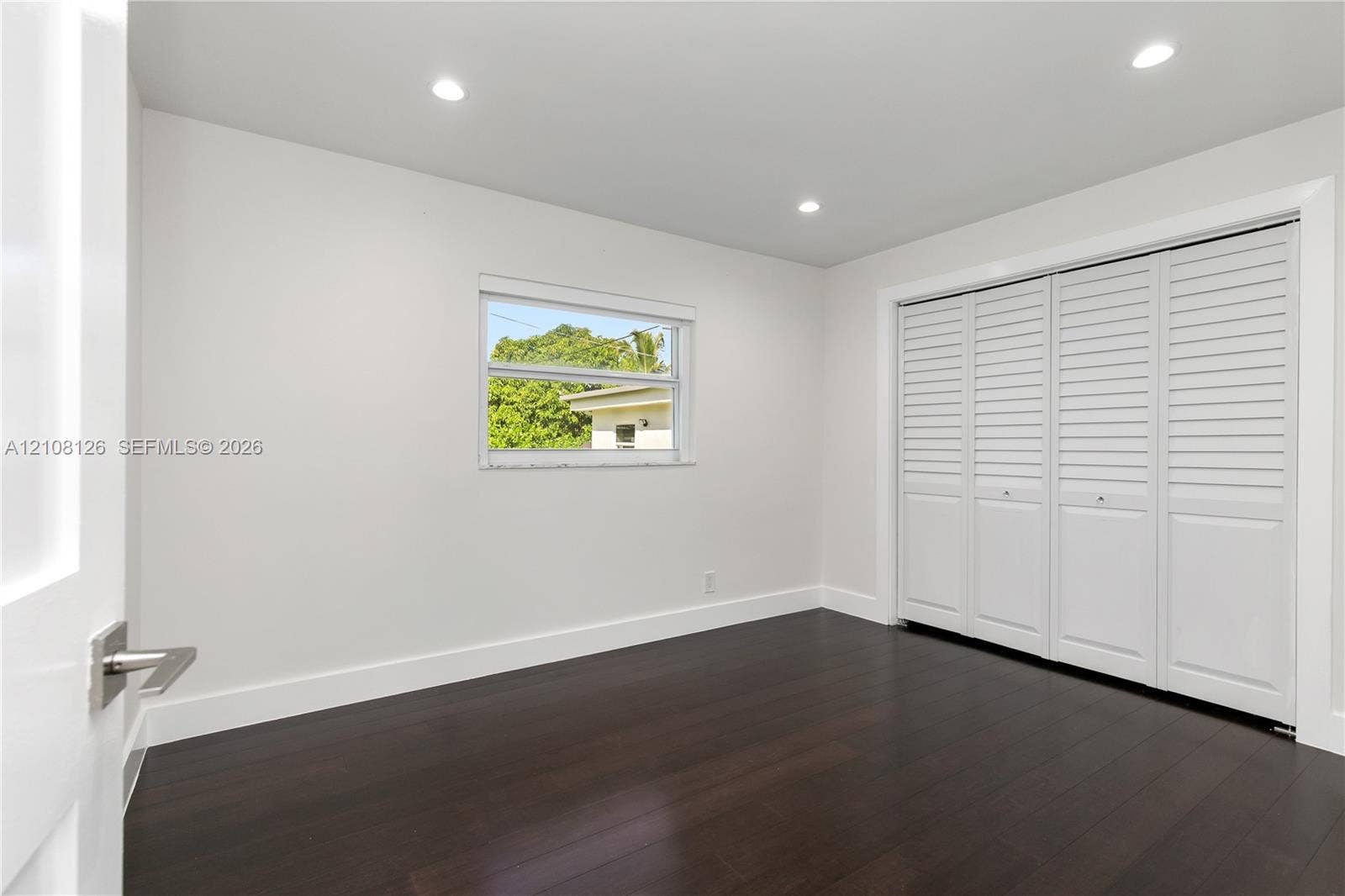 11700 NW 4th Street, Plantation, Plantation, FL 33325 Room featuring dark wood-finish flooring, recessed lighting, and a large bi-fold closet with white louvered panels