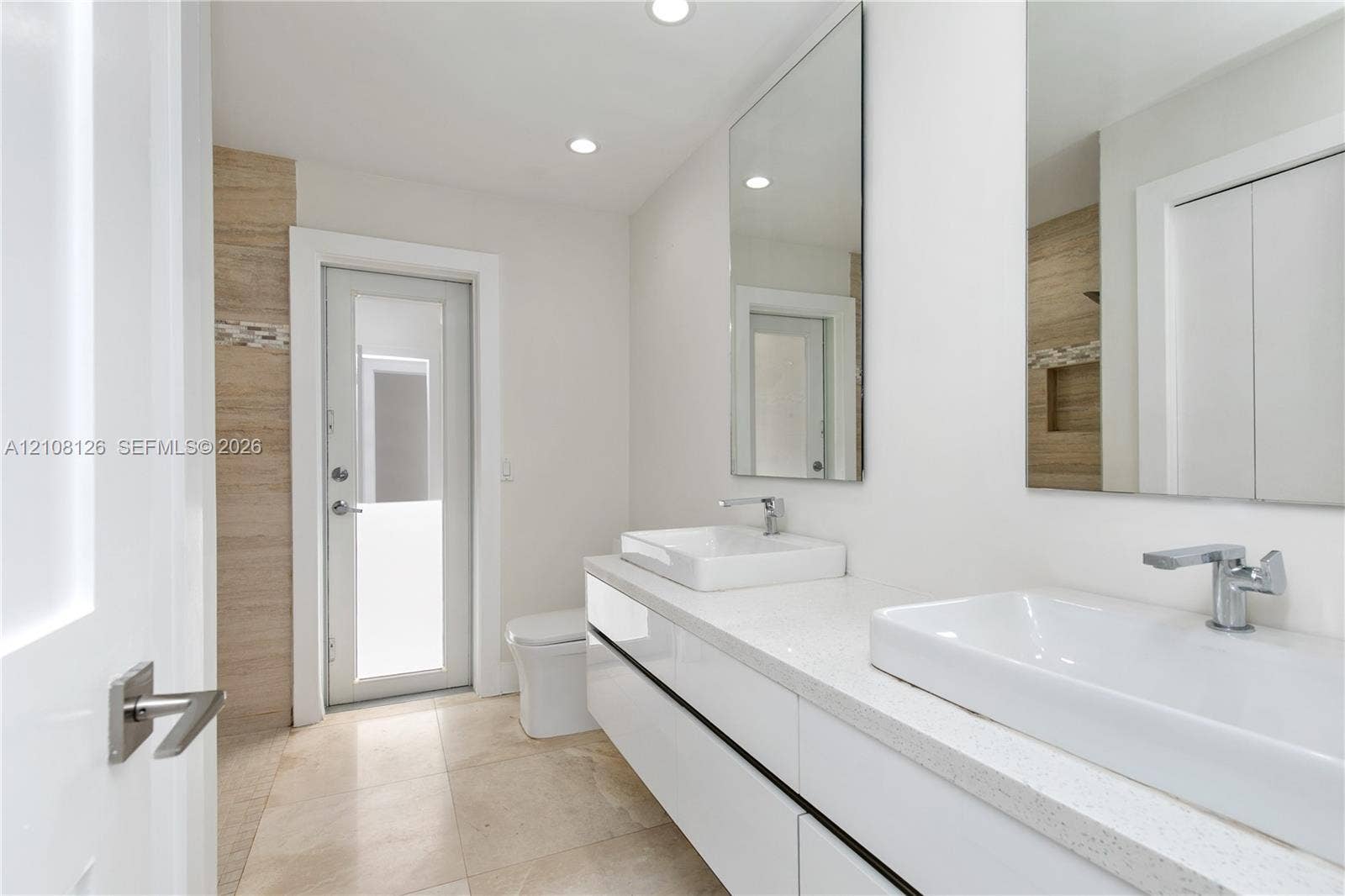 11700 NW 4th Street, Plantation, Plantation, FL 33325 Floating double vanity with rectangular vessel sinks, quartz countertop, chrome faucets, and large-format tile flooring