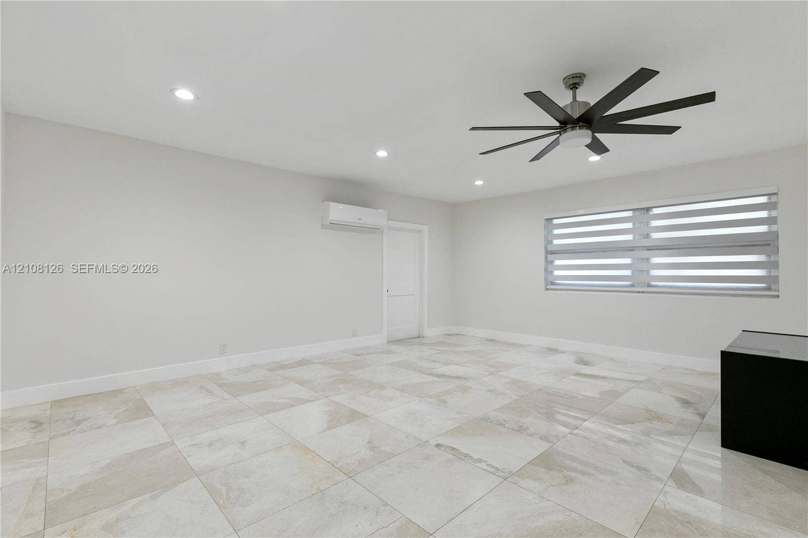 11700 NW 4th Street, Plantation, Plantation, FL 33325 Interior space featuring large-format tile flooring, a multi-blade ceiling fan, recessed lighting, and a wall-mounted climate control unit