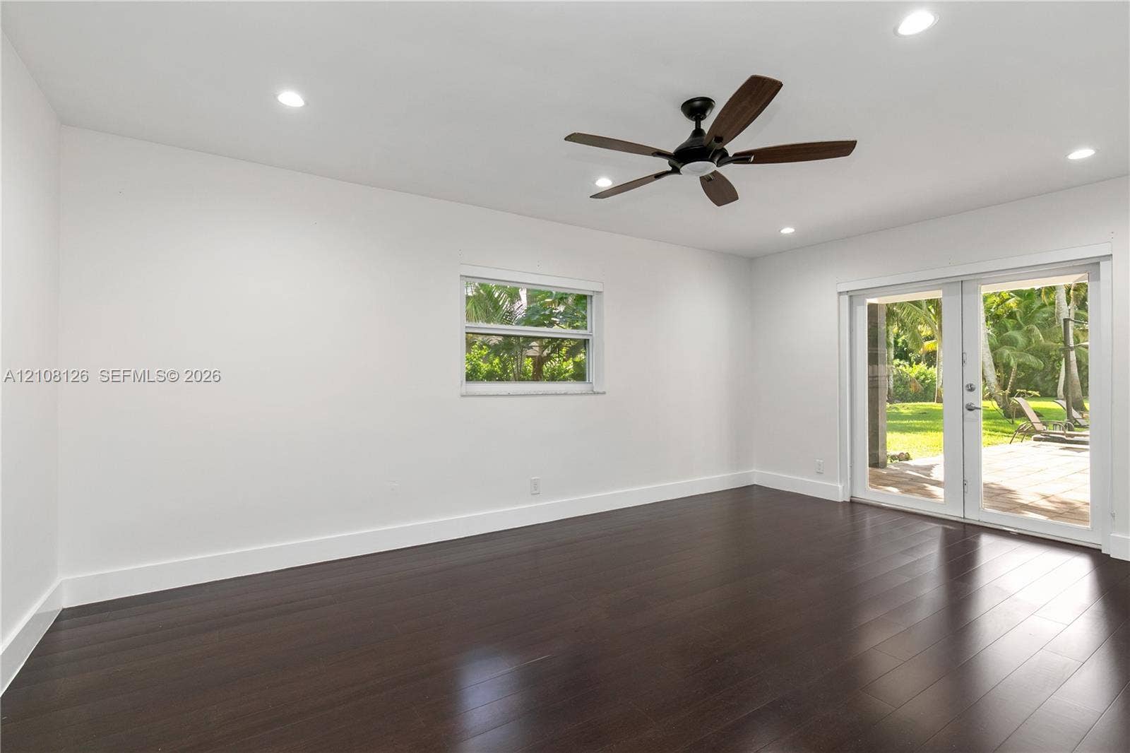 11700 NW 4th Street, Plantation, Plantation, FL 33325 Dark wood-finish flooring, recessed lighting, ceiling fan, single-hung window, and glass-paned double doors