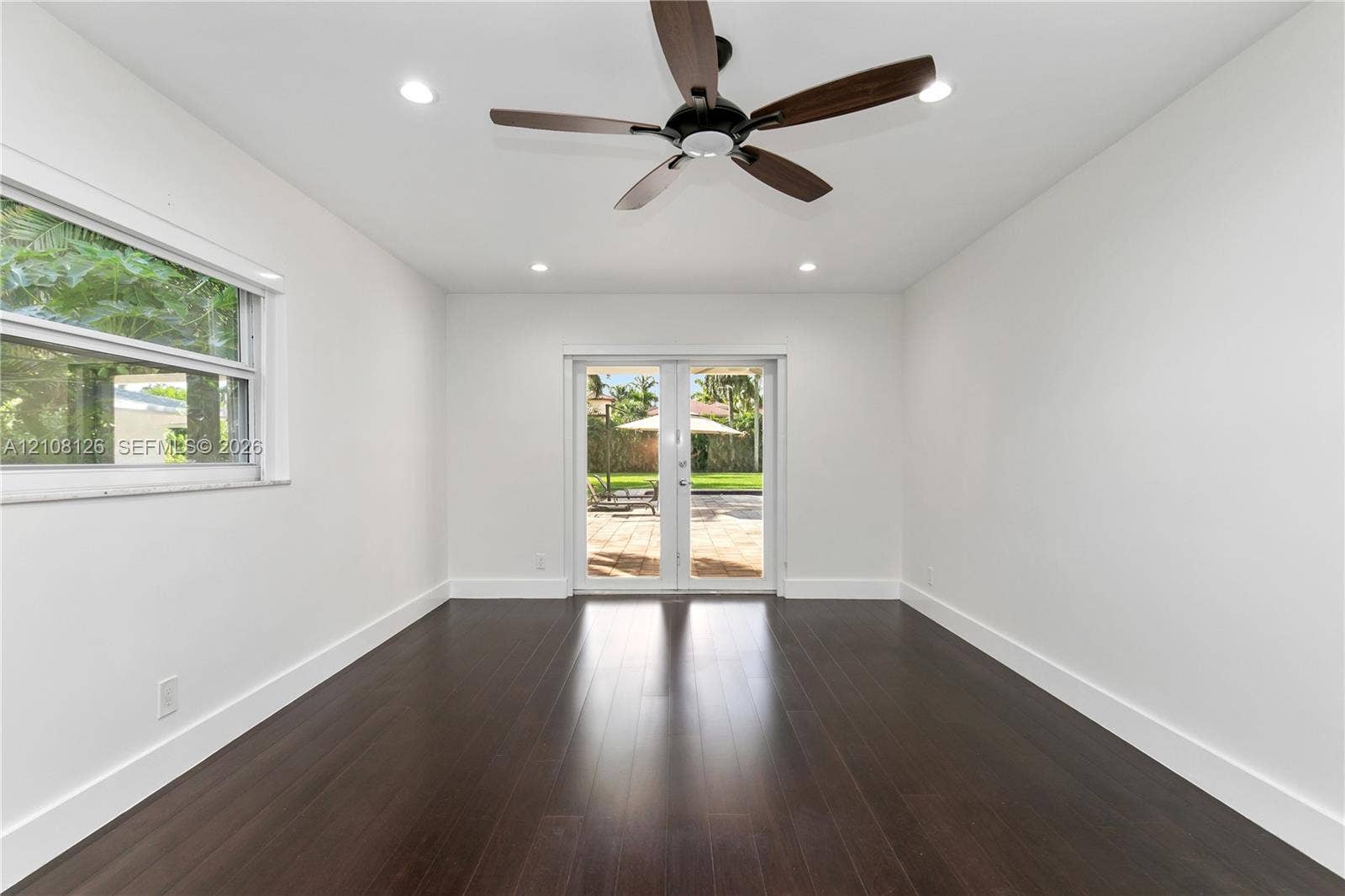 11700 NW 4th Street, Plantation, Plantation, FL 33325 Wood-finish flooring, recessed lighting, dark-toned ceiling fan, and glass-paneled French doors
