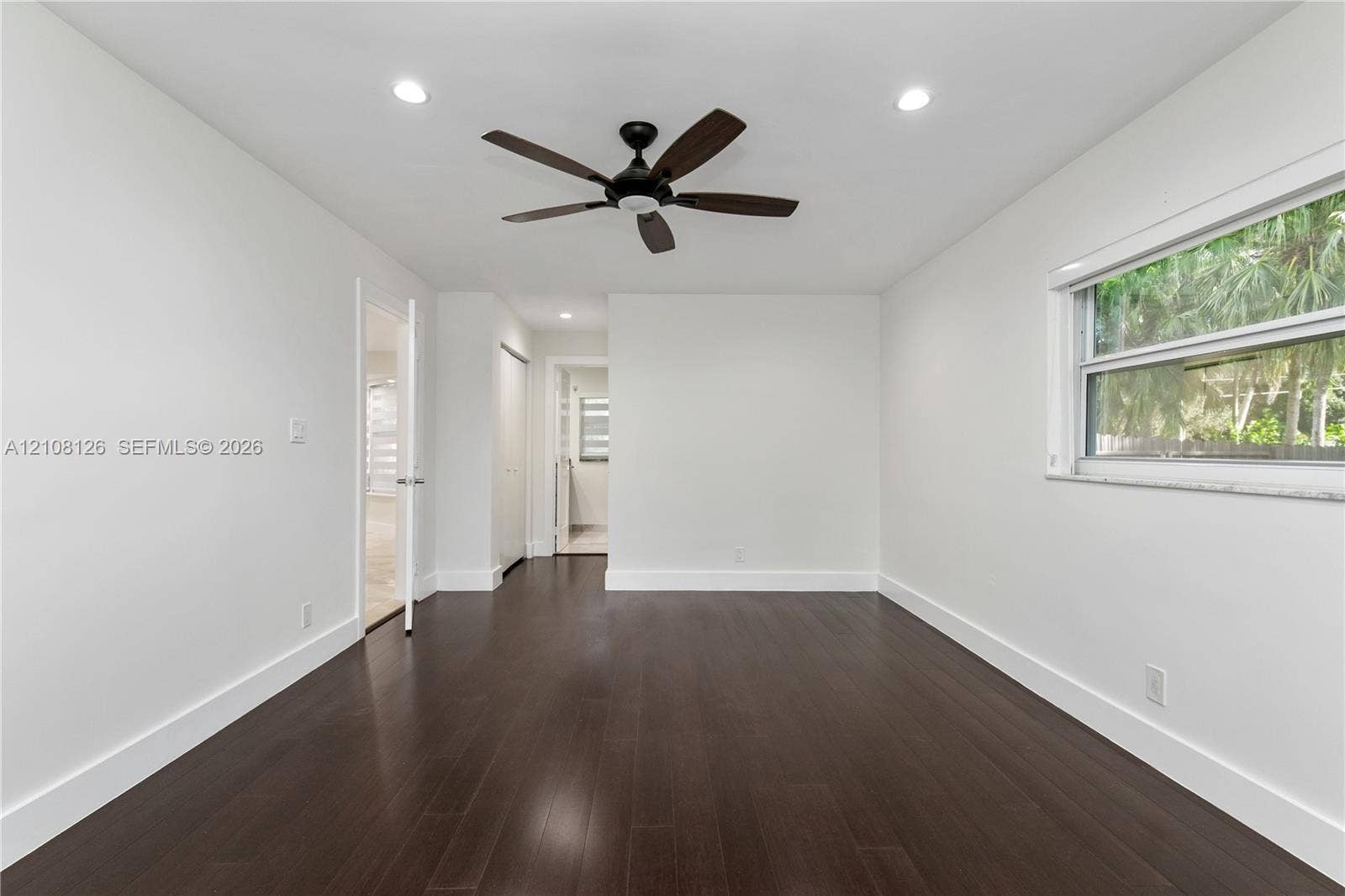 11700 NW 4th Street, Plantation, Plantation, FL 33325 Interior space featuring dark wood-finish flooring, neutral wall paint, recessed lighting, and a ceiling fan