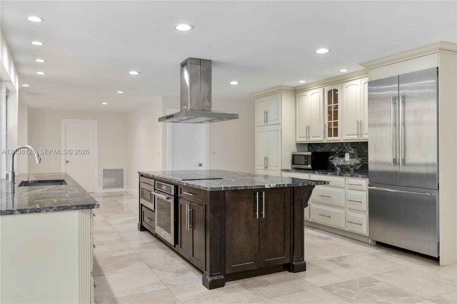 11700 NW 4th Street, Plantation, Plantation, FL 33325 Kitchen featuring a central island with a built-in oven, stone-finish countertops, stainless steel appliances, recessed ceiling lighting, and tile flooring