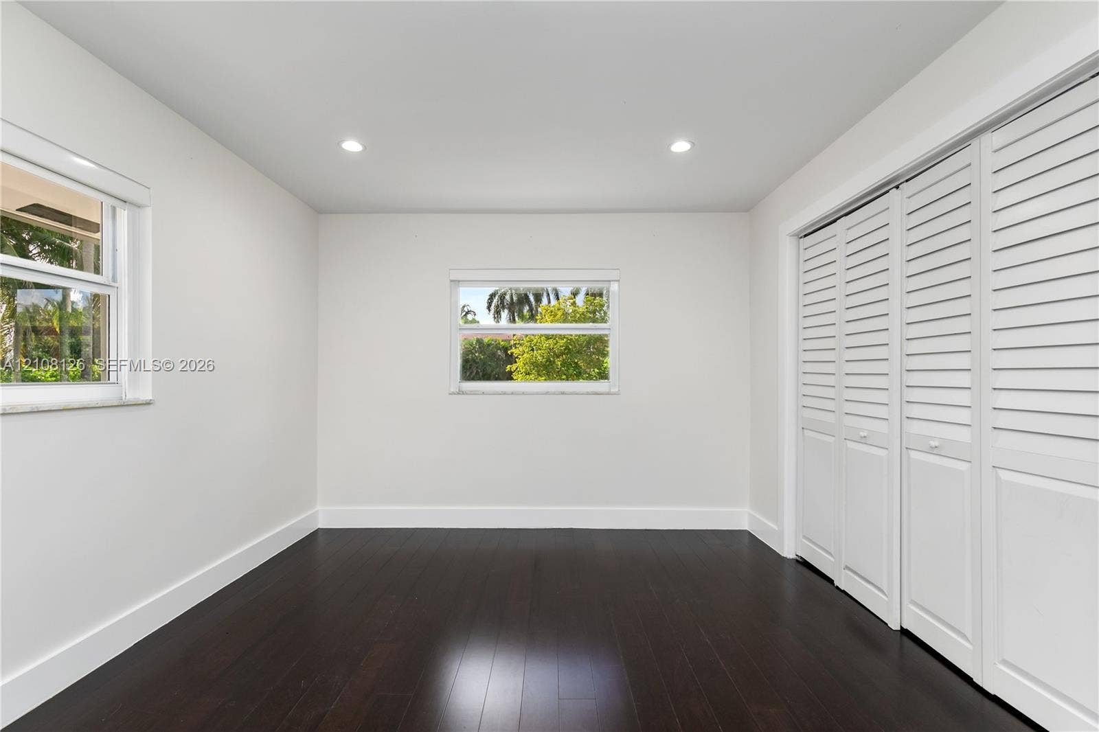 11700 NW 4th Street, Plantation, Plantation, FL 33325 Dark wood-finish flooring, recessed lighting, and double bi-fold louvered closet doors