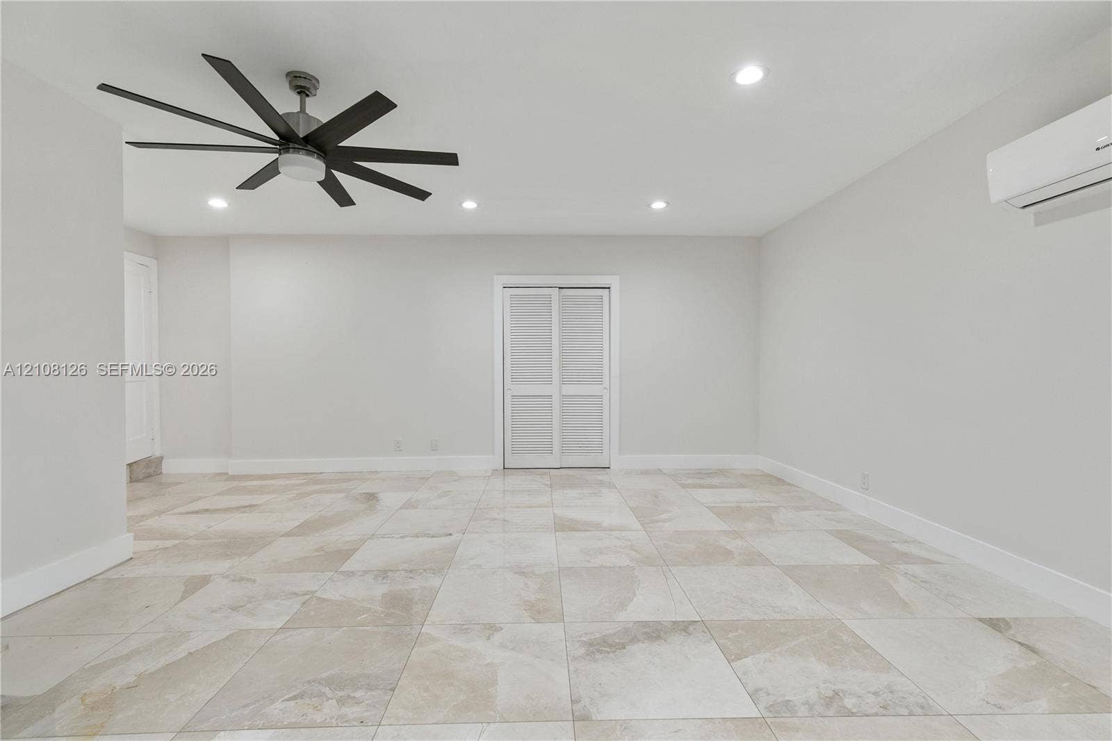11700 NW 4th Street, Plantation, Plantation, FL 33325 Large-format tile flooring, multi-blade ceiling fan, recessed lighting, and wall-mounted climate control unit