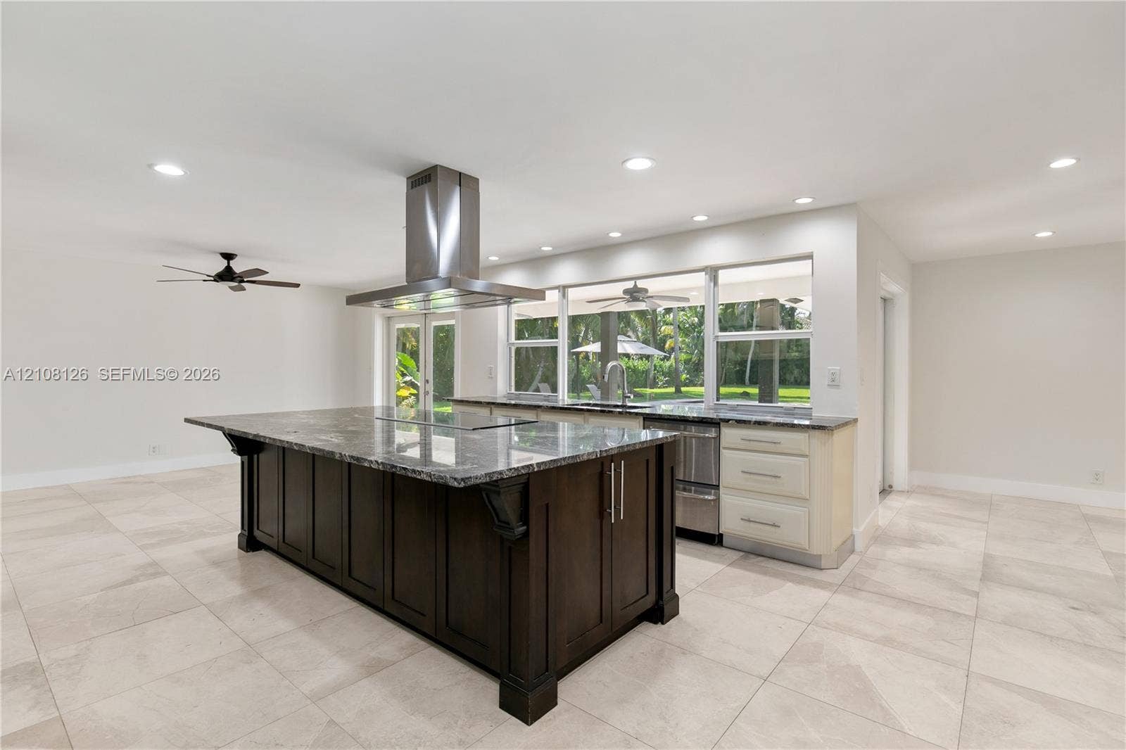 11700 NW 4th Street, Plantation, Plantation, FL 33325 Kitchen featuring a large central island with dark cabinetry, stone-finish countertops, stainless steel professional-grade range hood, recessed lighting, and large-format tile flooring