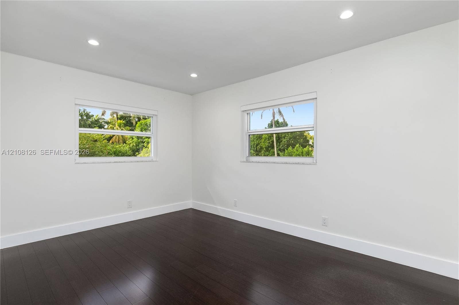 11700 NW 4th Street, Plantation, Plantation, FL 33325 Neutral-toned room with wood-finish flooring, recessed lighting, and double-pane windows