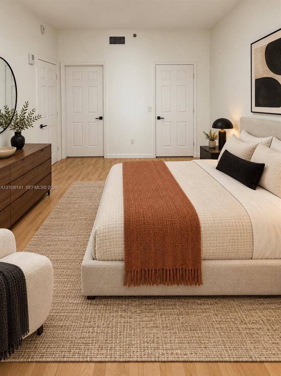 3135 NE 184th Street, #2205, Aventura, FL 33160 Wood-finish flooring, two six-panel interior doors with matte black hardware, and crisp neutral wall finish