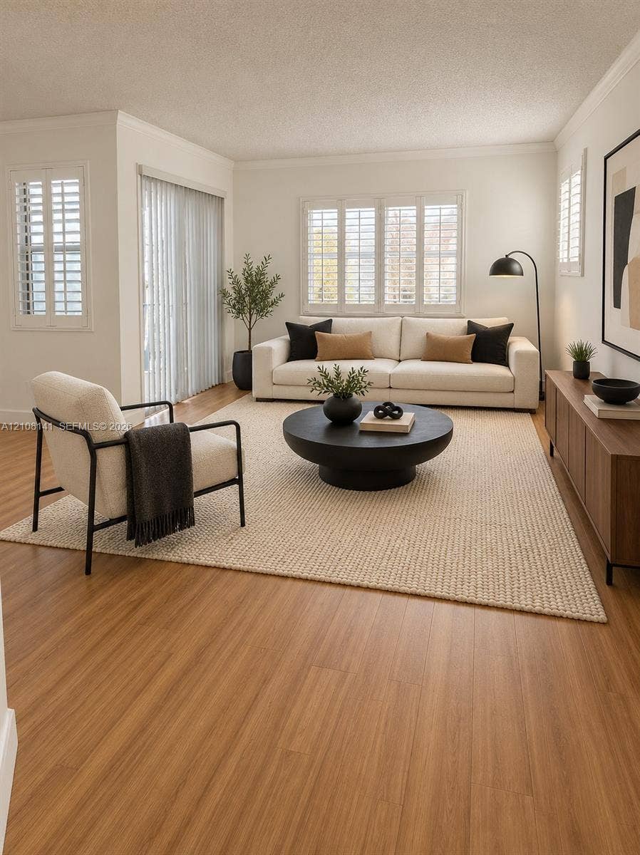 3135 NE 184th Street, #2205, Aventura, FL 33160 Living area featuring wood-finish flooring, plantation shutters, and sliding glass door access