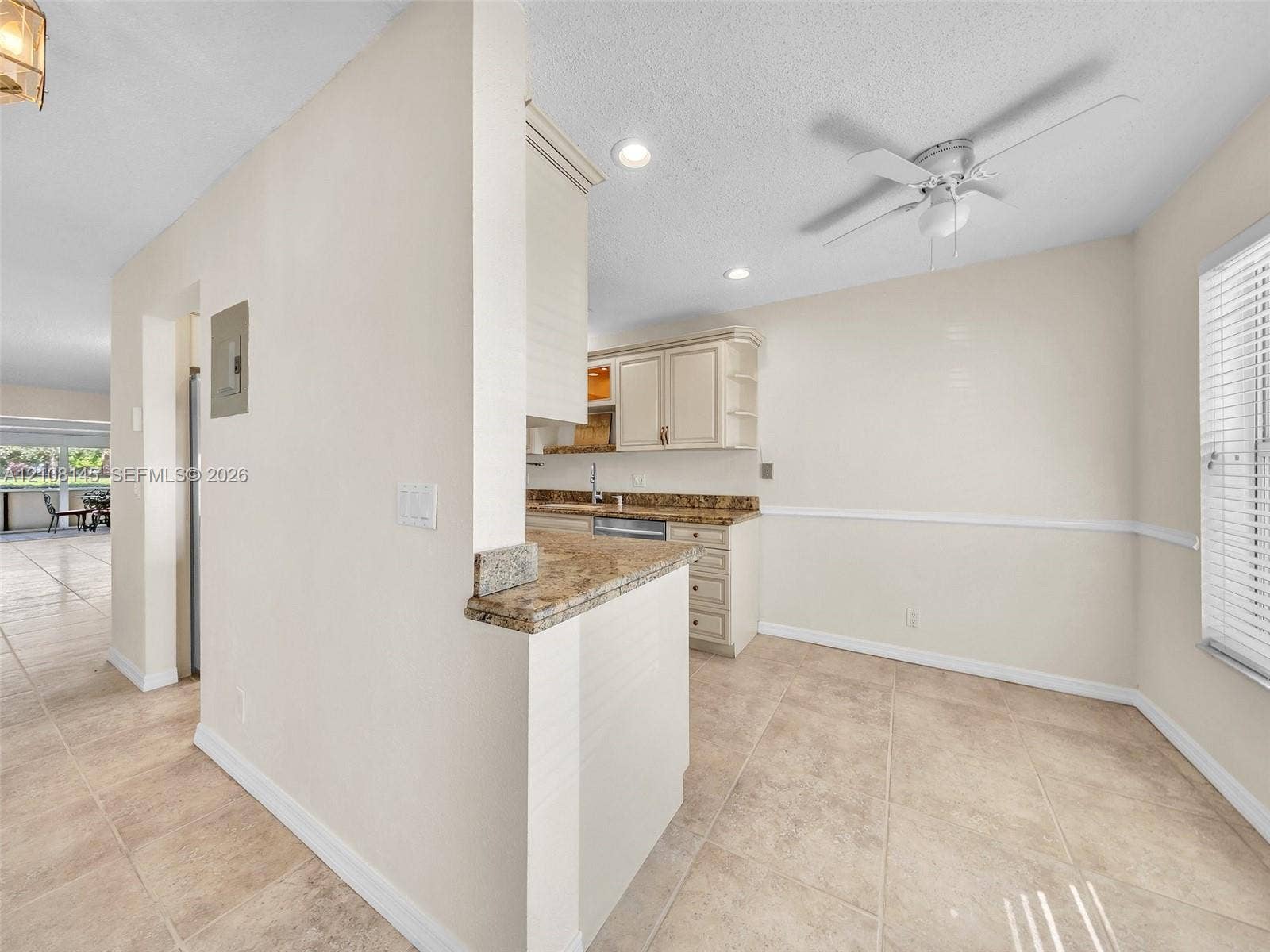 1020 Citrus Way, #101, Delray Beach, FL 33445 Kitchen featuring cabinetry with stone-surface countertops, tile flooring, recessed lighting, and a ceiling fan