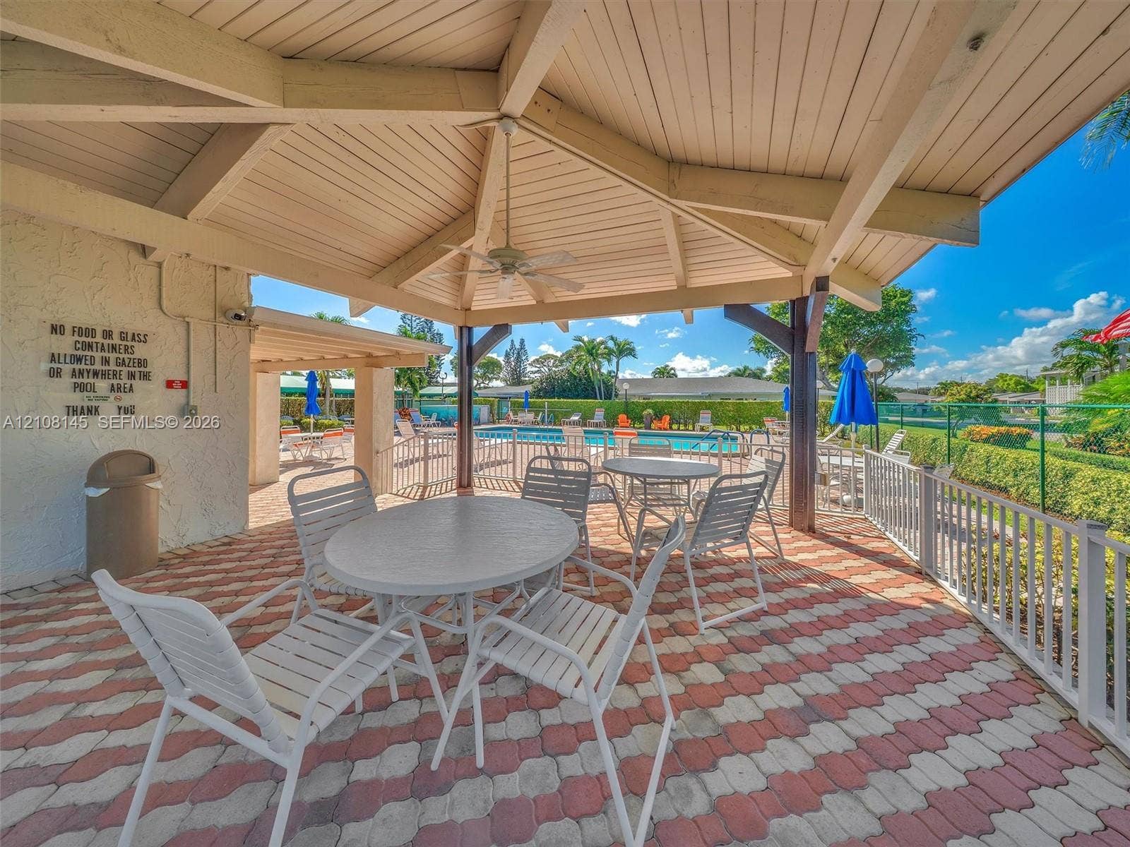 1020 Citrus Way, #101, Delray Beach, FL 33445 Covered outdoor gazebo featuring a vaulted wood-beam ceiling, ceiling fan, and decorative brick paver flooring