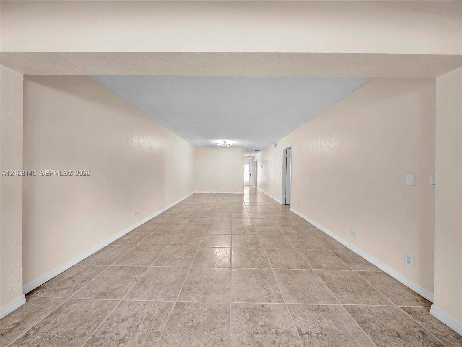 1020 Citrus Way, #101, Delray Beach, FL 33445 Expansive room featuring neutral wall paint, large format tile flooring, and a recessed ceiling design