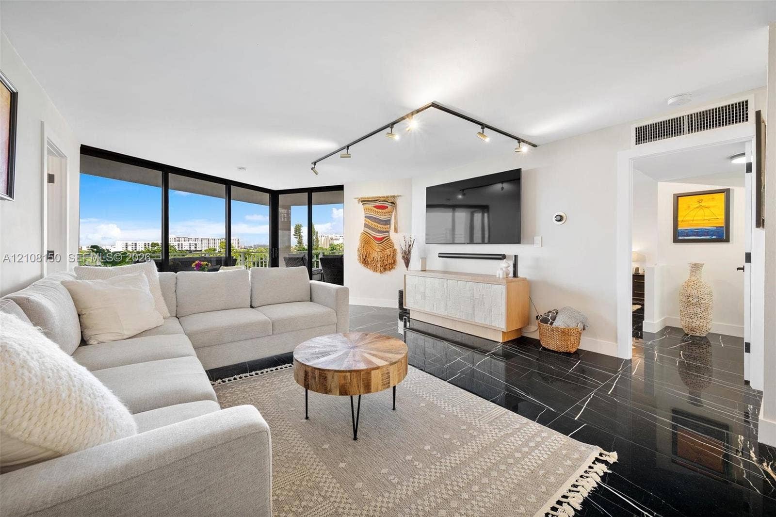 1000 Quayside Terrace, #709, Miami, Miami, FL 33138 Living area featuring floor-to-ceiling windows, black polished stone-finish flooring, and adjustable track lighting