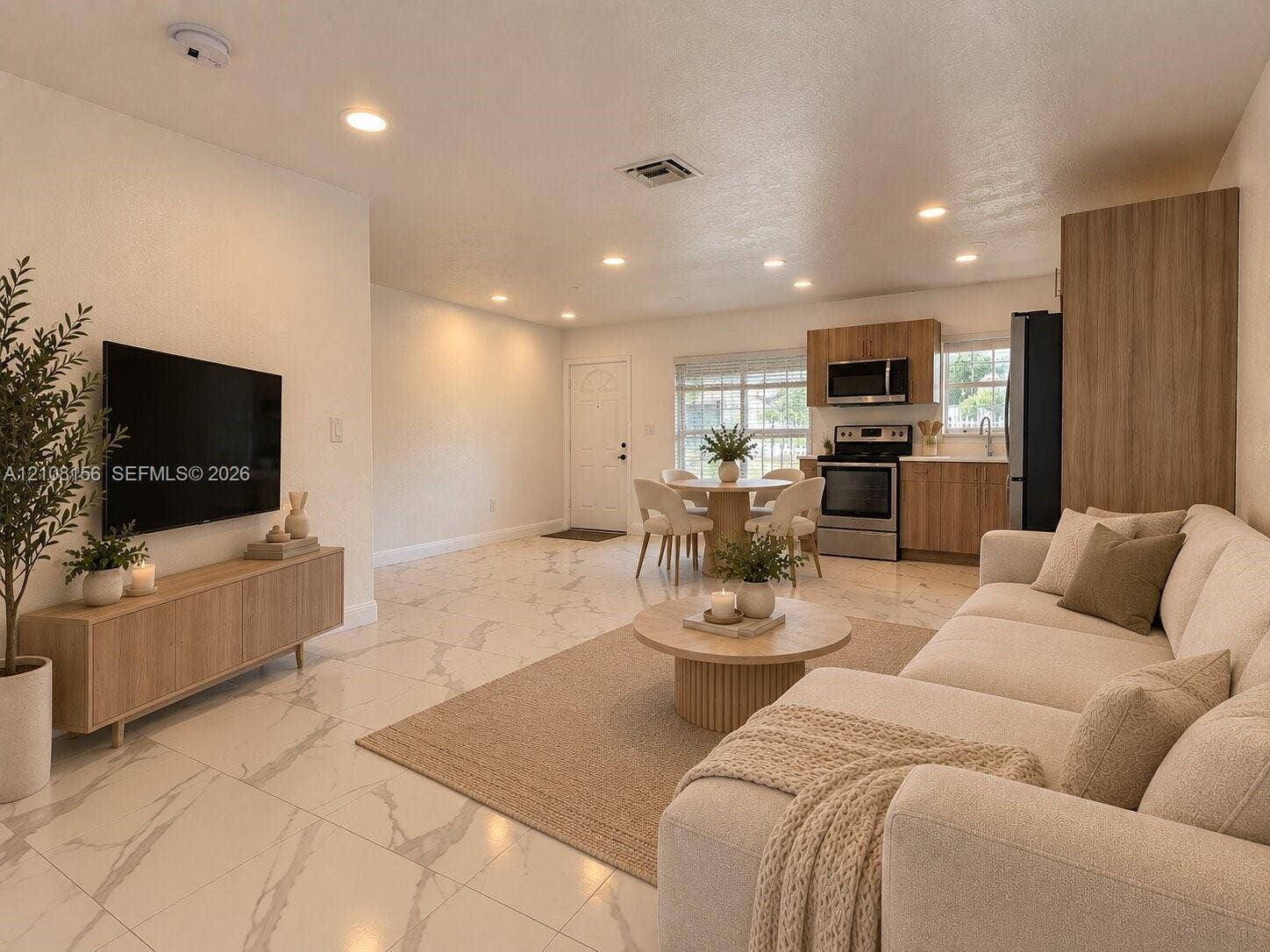 17175 NW 41st Avenue, Miami Gardens, FL 33055 Large-format tile flooring with marble-style veining, recessed lighting, and kitchen featuring wood-finish cabinetry, stainless steel appliances, and built-in pantry storage