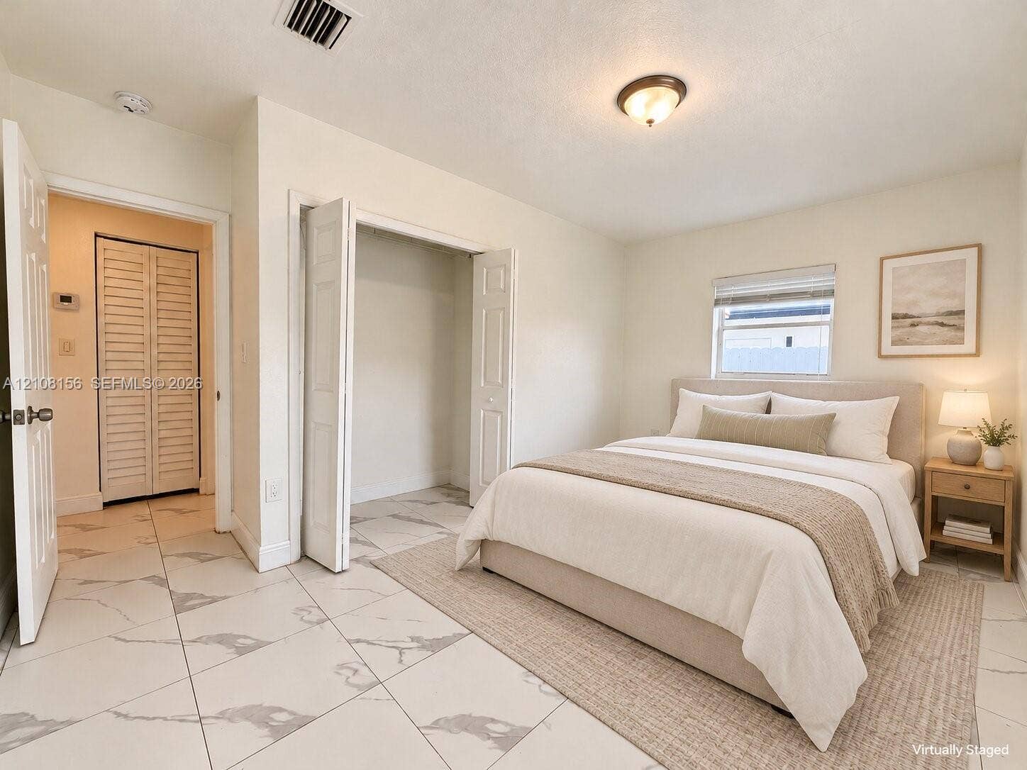 17175 NW 41st Avenue, Miami Gardens, FL 33055 Large-format tile flooring with a light veined pattern, dual closets with bi-fold louvered doors, and a neutral color palette