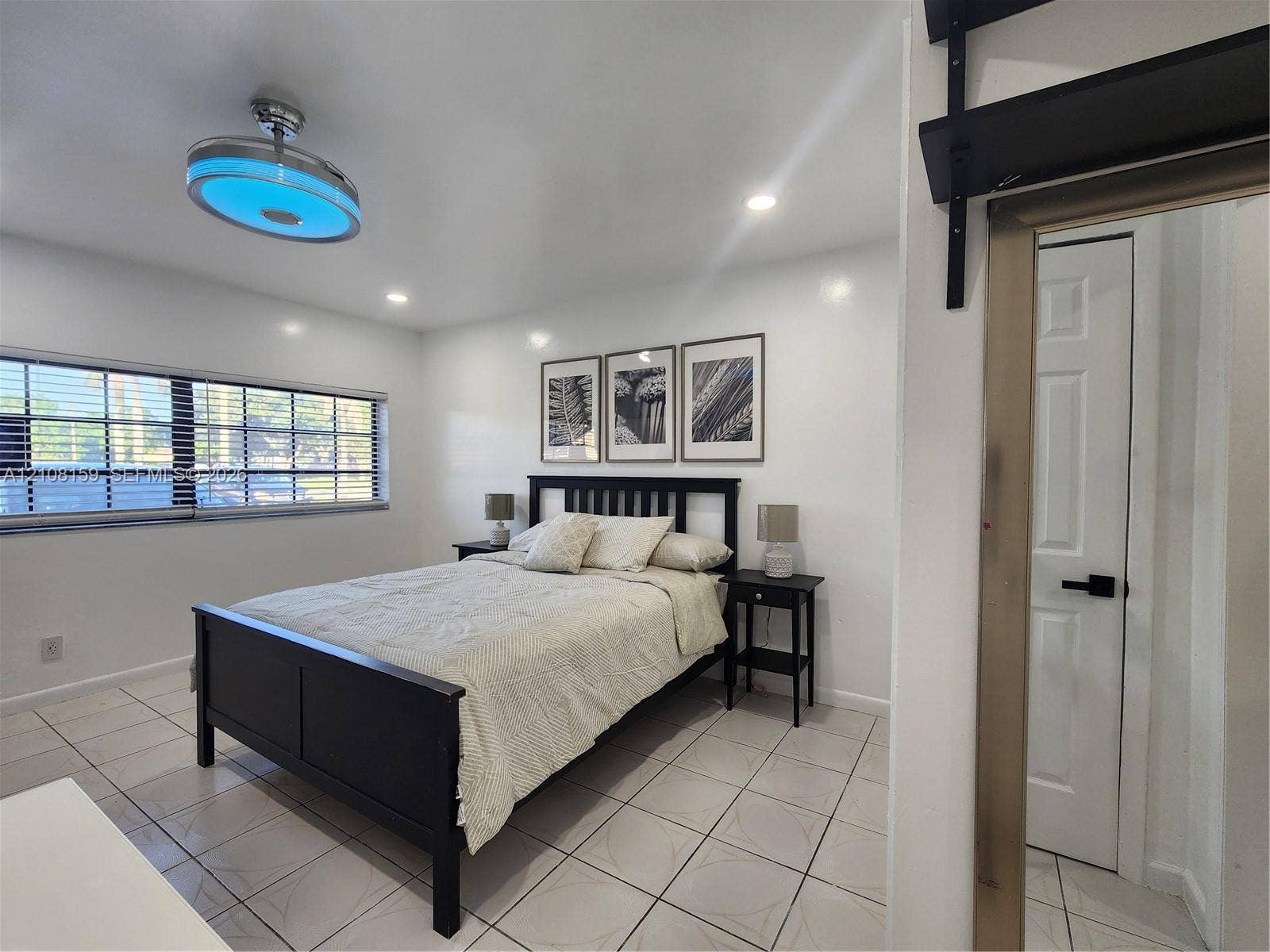 Ceramic tile flooring, multi-pane windows, recessed ceiling lighting, and a modern circular ceiling fan