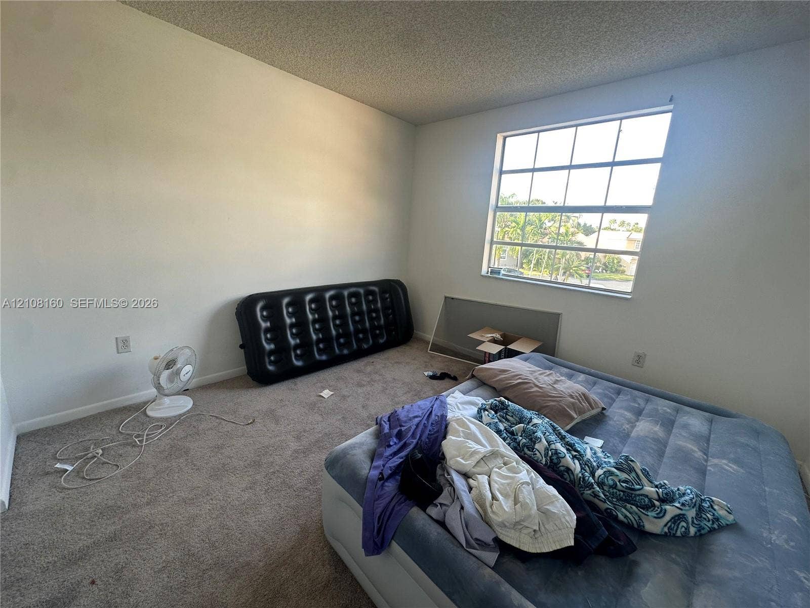 1262 NW 126th Avenue, Sunrise, FL 33323 Room featuring neutral wall finishes, carpeting, and a multi-pane window