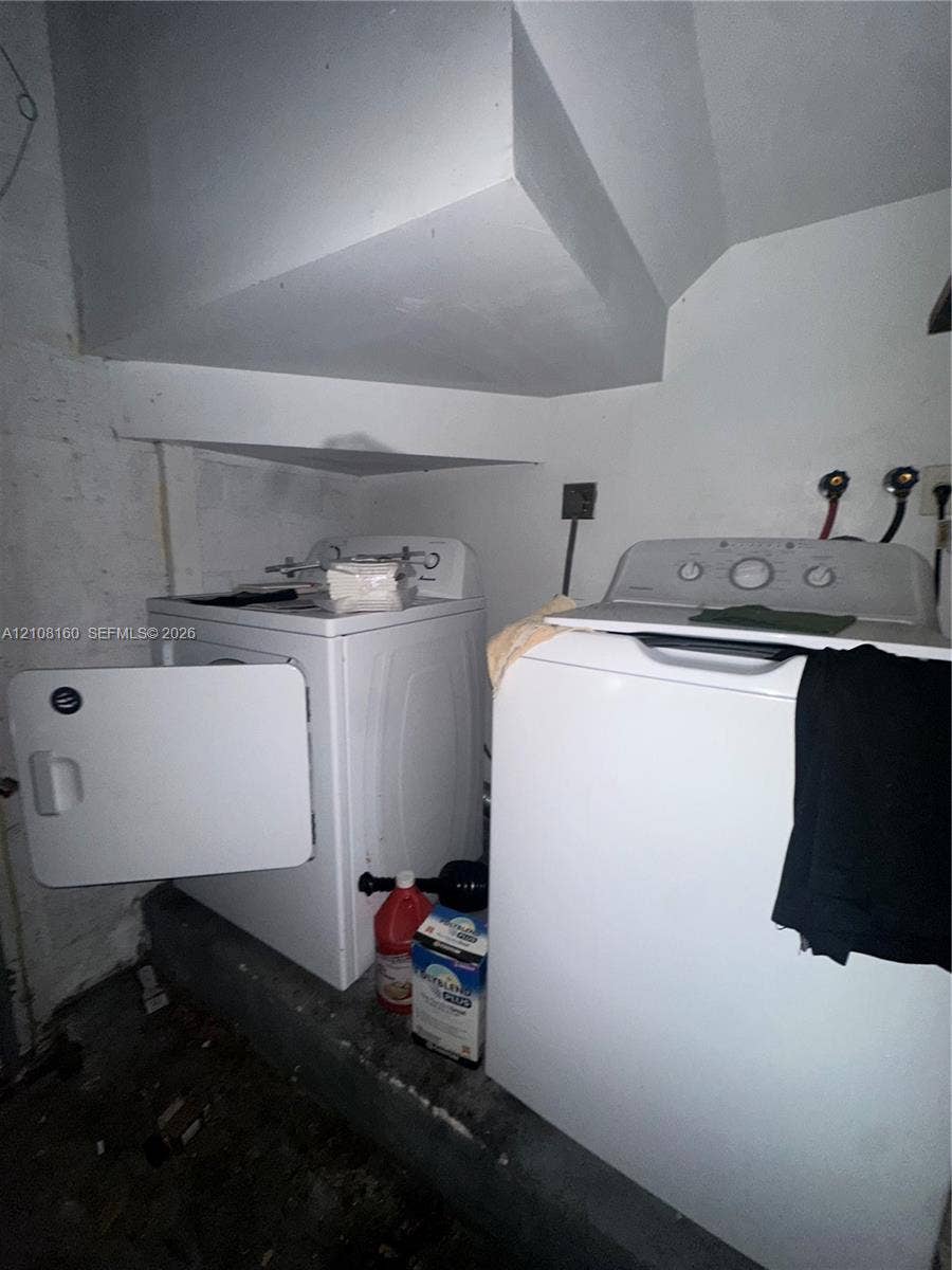 1262 NW 126th Avenue, Sunrise, FL 33323 Dedicated laundry area featuring dual water hookups and an elevated concrete platform