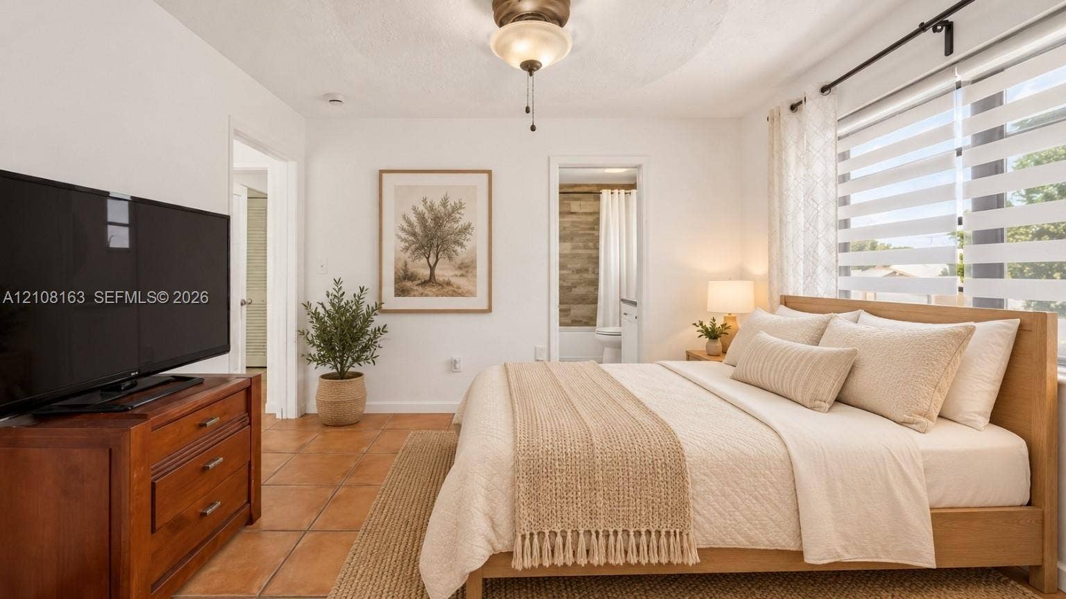 11510 SW 5th Street, #1, Sweetwater, Sweetwater, FL 33174 Ceramic tile flooring, neutral wall finishes, central ceiling fan with integrated lighting, and horizontal tiered window treatments