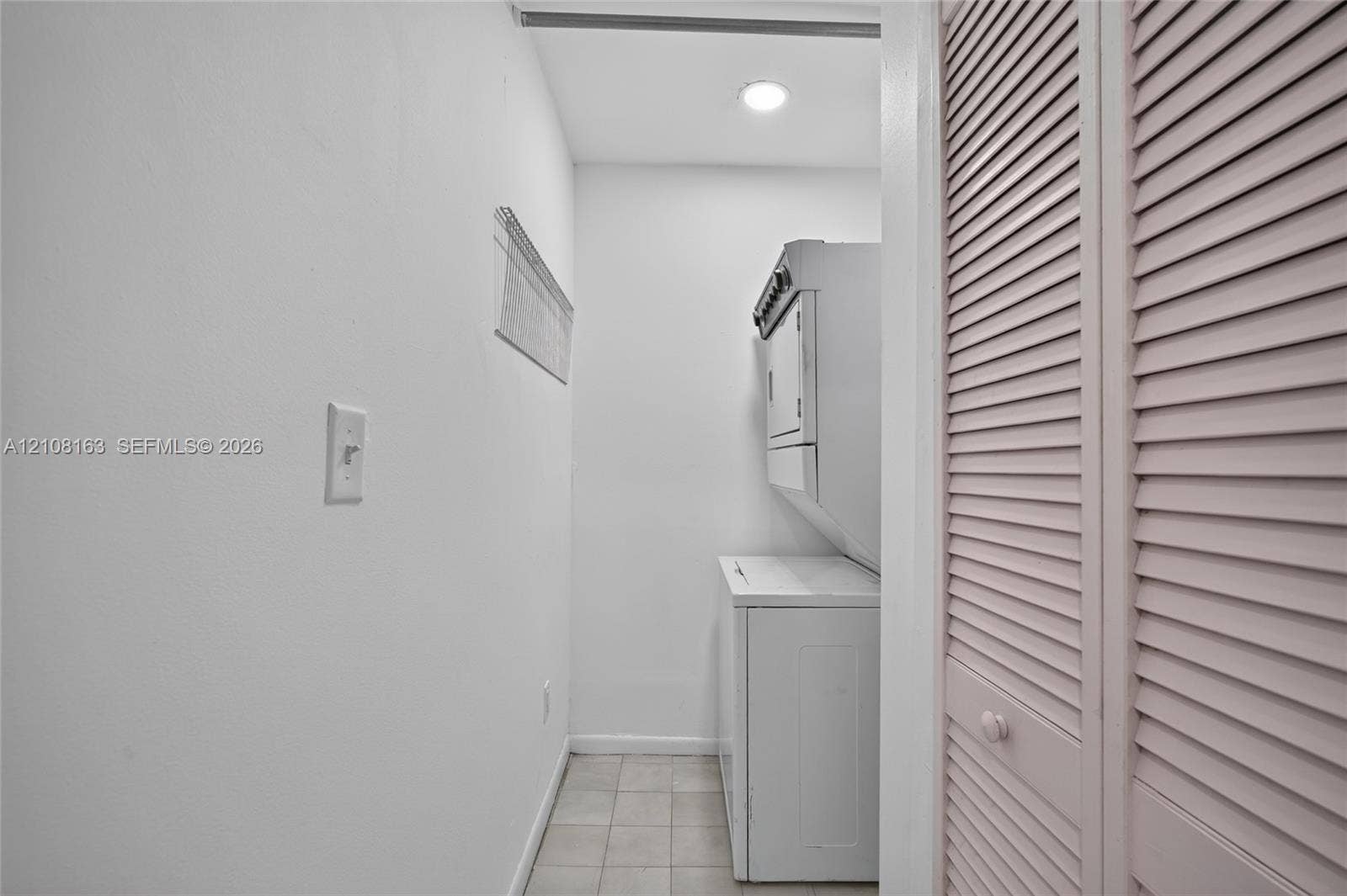 11510 SW 5th Street, #1, Sweetwater, Sweetwater, FL 33174 Bathroom featuring a stone-finish tile tub surround, white vanity cabinet with a stone-finish countertop, undermount sink, and wood-finish tile flooring