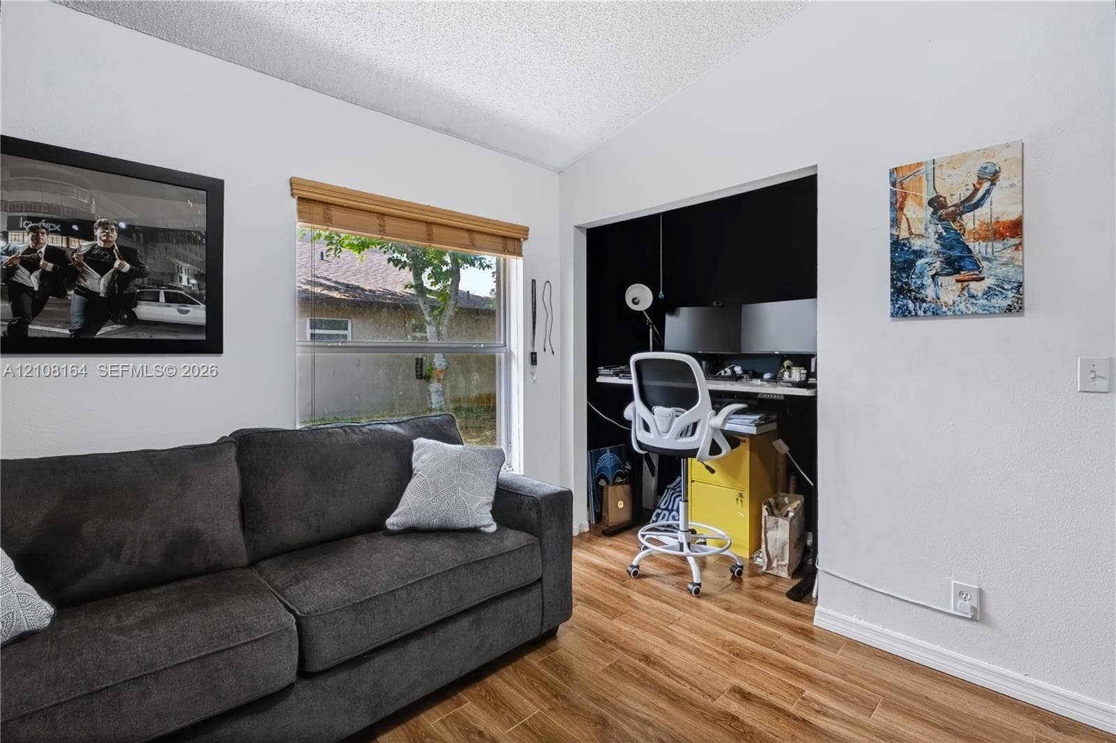 3983 NW 122nd Terrace, Sunrise, FL 33323 Wood-finish flooring, recessed alcove, and window with natural light