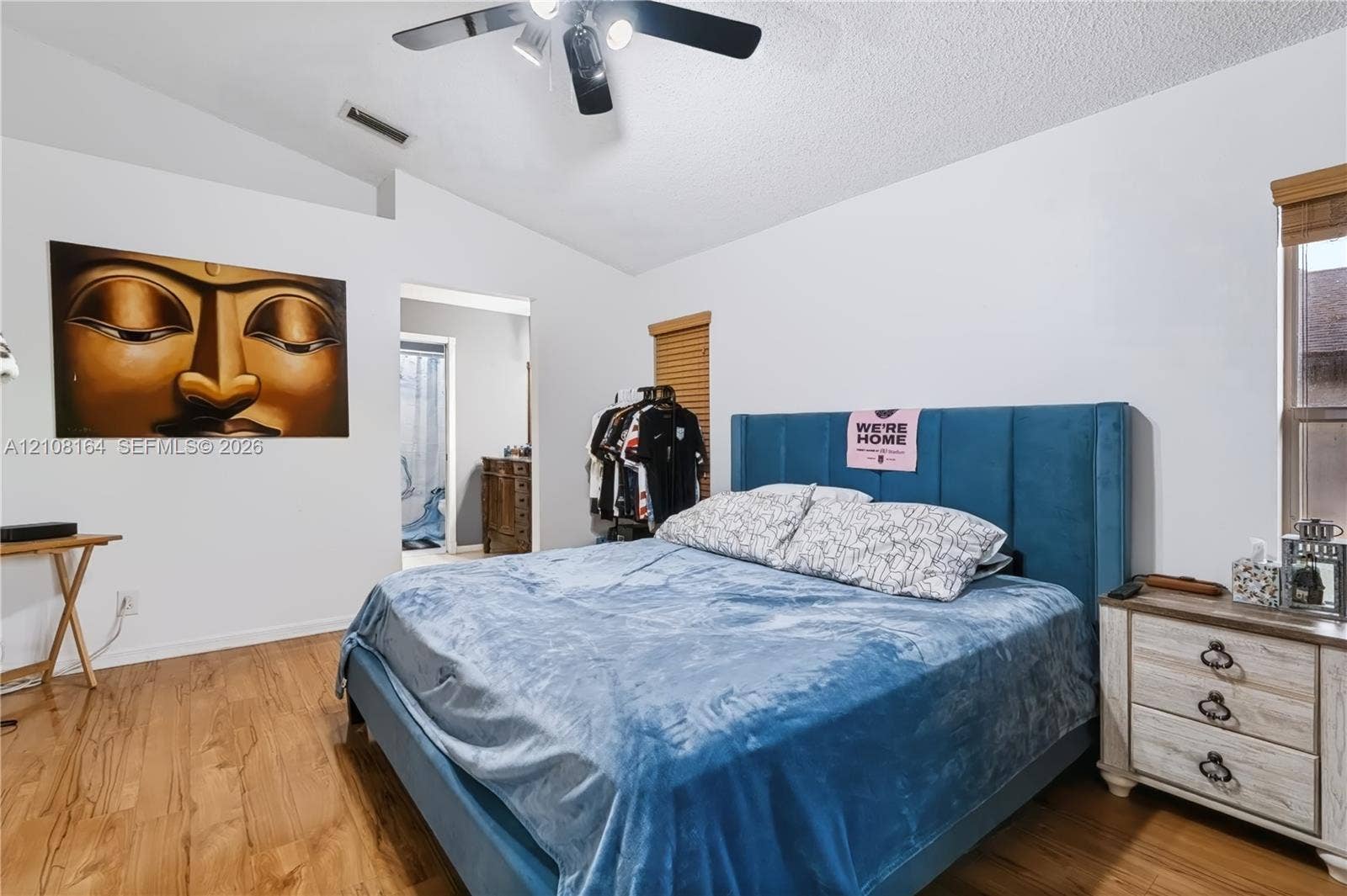 3983 NW 122nd Terrace, Sunrise, FL 33323 Vaulted ceiling with integrated multi-light ceiling fan, wood-finish flooring, and horizontal window blinds