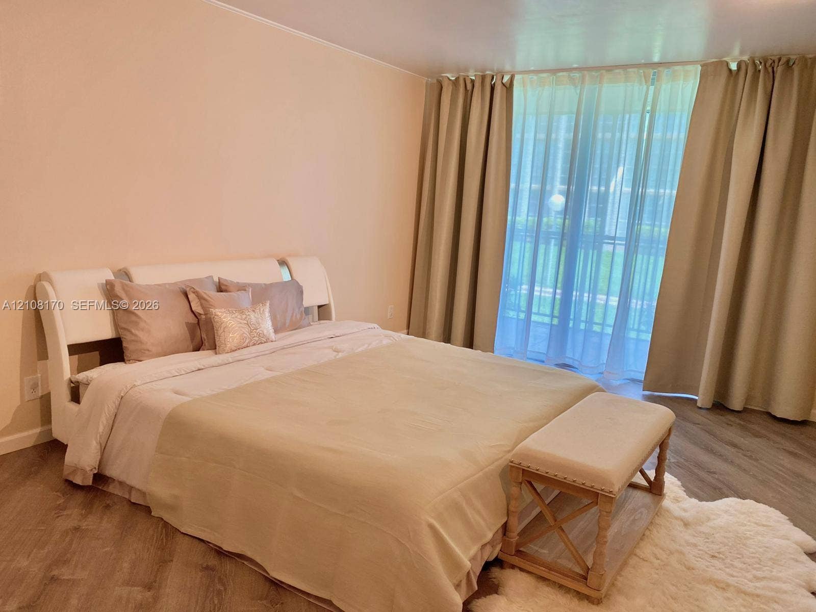 801 Three Islands Boulevard, #108, Hallandale Beach, FL 33009 Wood-finish flooring, floor-to-ceiling windows, and sliding glass door