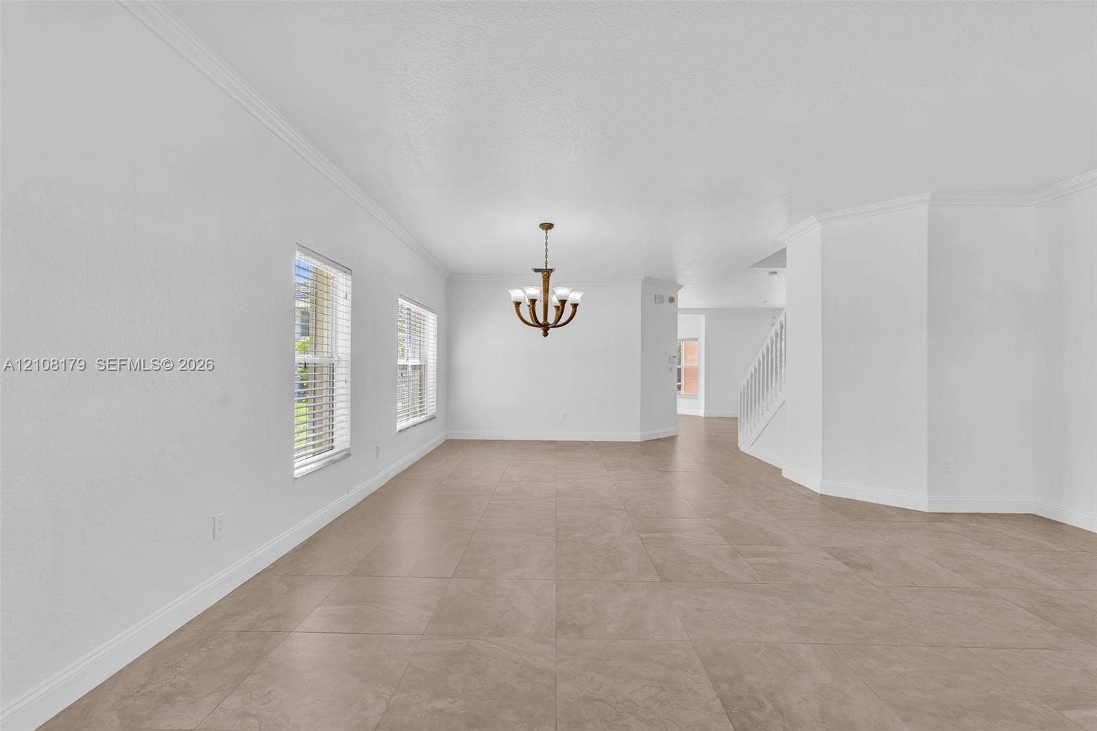 15854 SW 14th Court, Pembroke Pines, Pembroke Pines, FL 33027 Large-format tile flooring, multi-light chandelier with metallic finish, crown molding, and staircase with white railings
