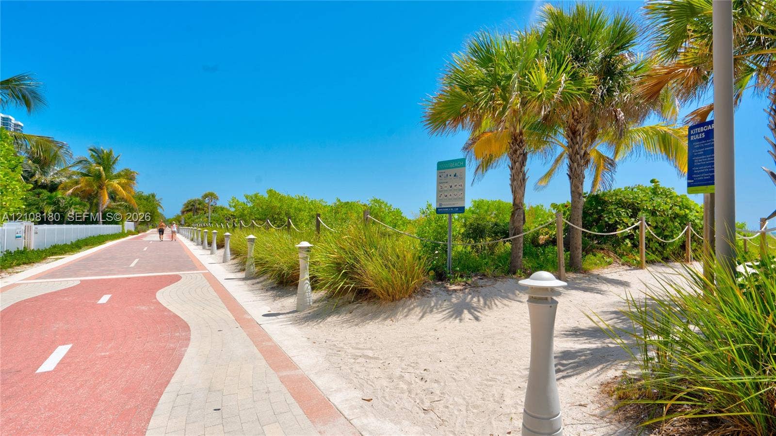 2457 Collins Avenue, #1501, Miami Beach, FL 33140 Paved multi-use trail featuring a brick-paver border, rope-fenced pathways, native landscaping, and mature palm trees