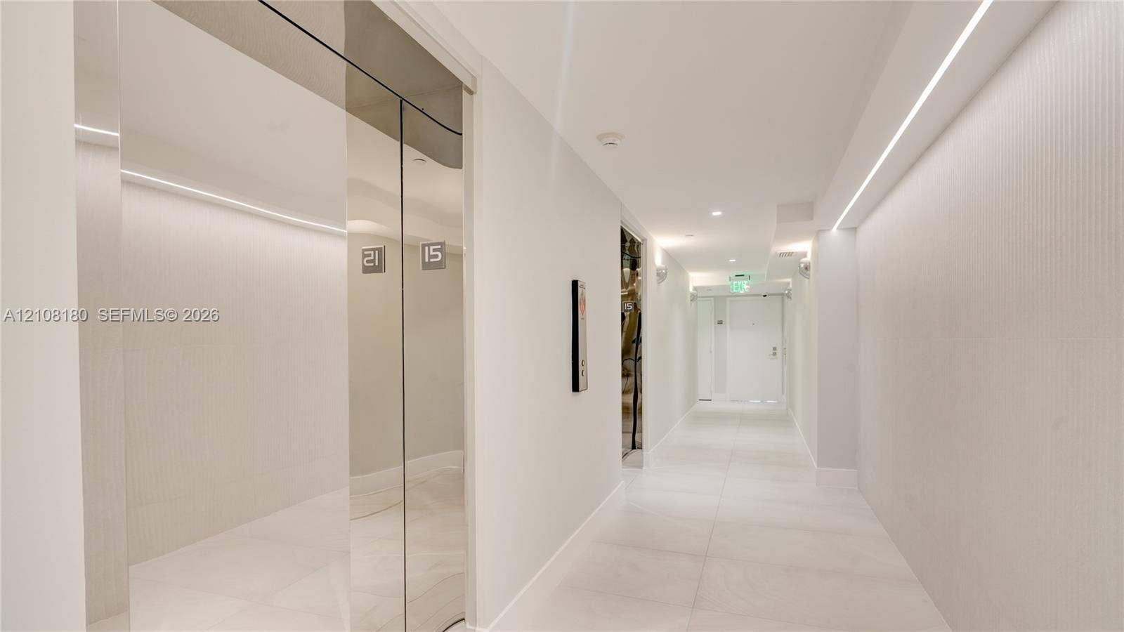 2457 Collins Avenue, #1501, Miami Beach, FL 33140 Polished chrome elevator doors, textured wall cladding, large-format tile flooring, and integrated linear LED ceiling lighting