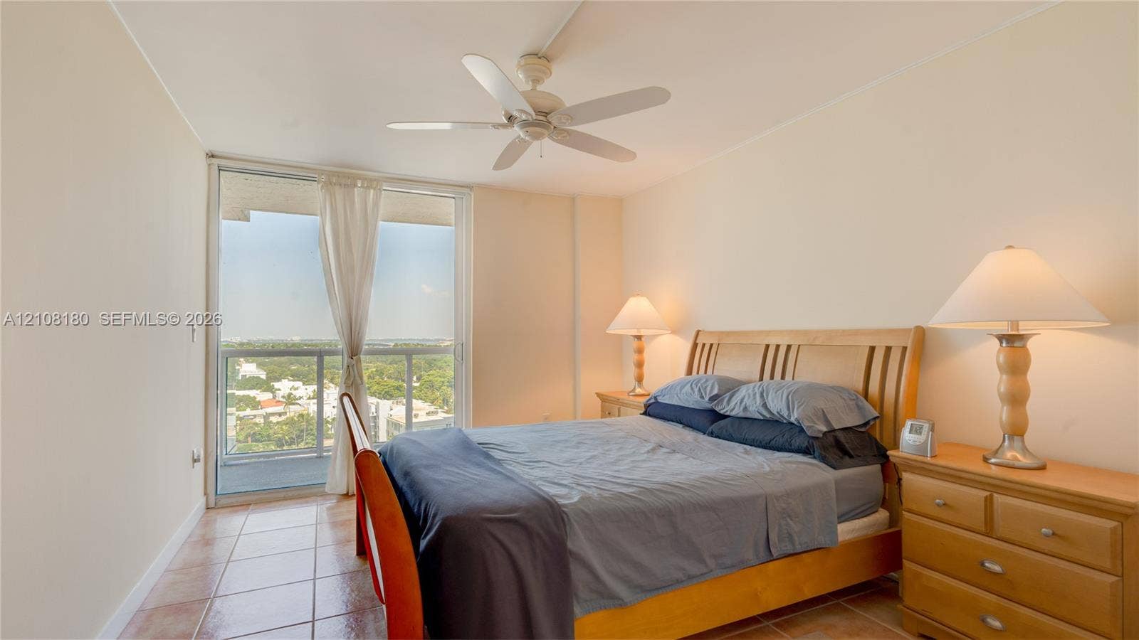 2457 Collins Avenue, #1501, Miami Beach, FL 33140 Room featuring tile flooring, a white ceiling fan, and sliding glass doors with a metal railing