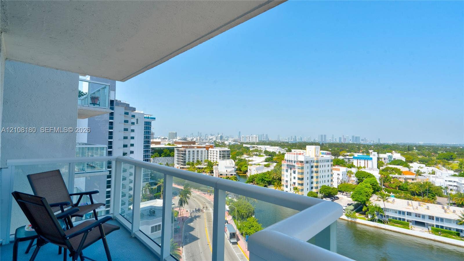 2457 Collins Avenue, #1501, Miami Beach, FL 33140 Private balcony featuring a glass panel railing and elevated cityscape scenery