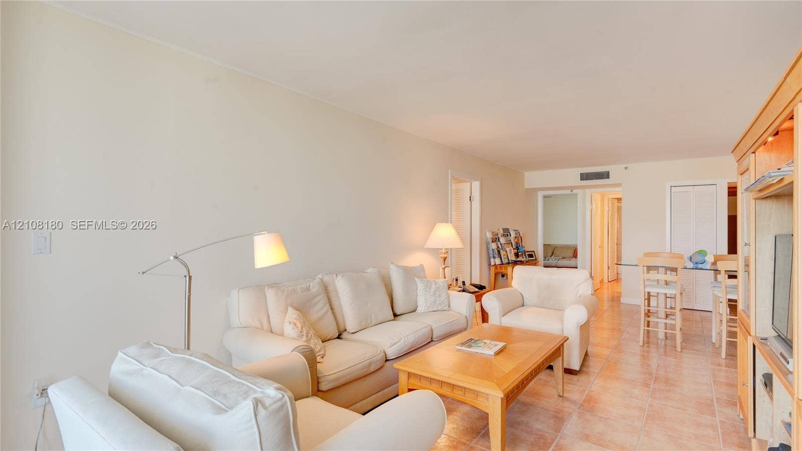 2457 Collins Avenue, #1501, Miami Beach, FL 33140 Open-concept living space featuring ceramic tile flooring, built-in cabinetry, and neutral wall tones