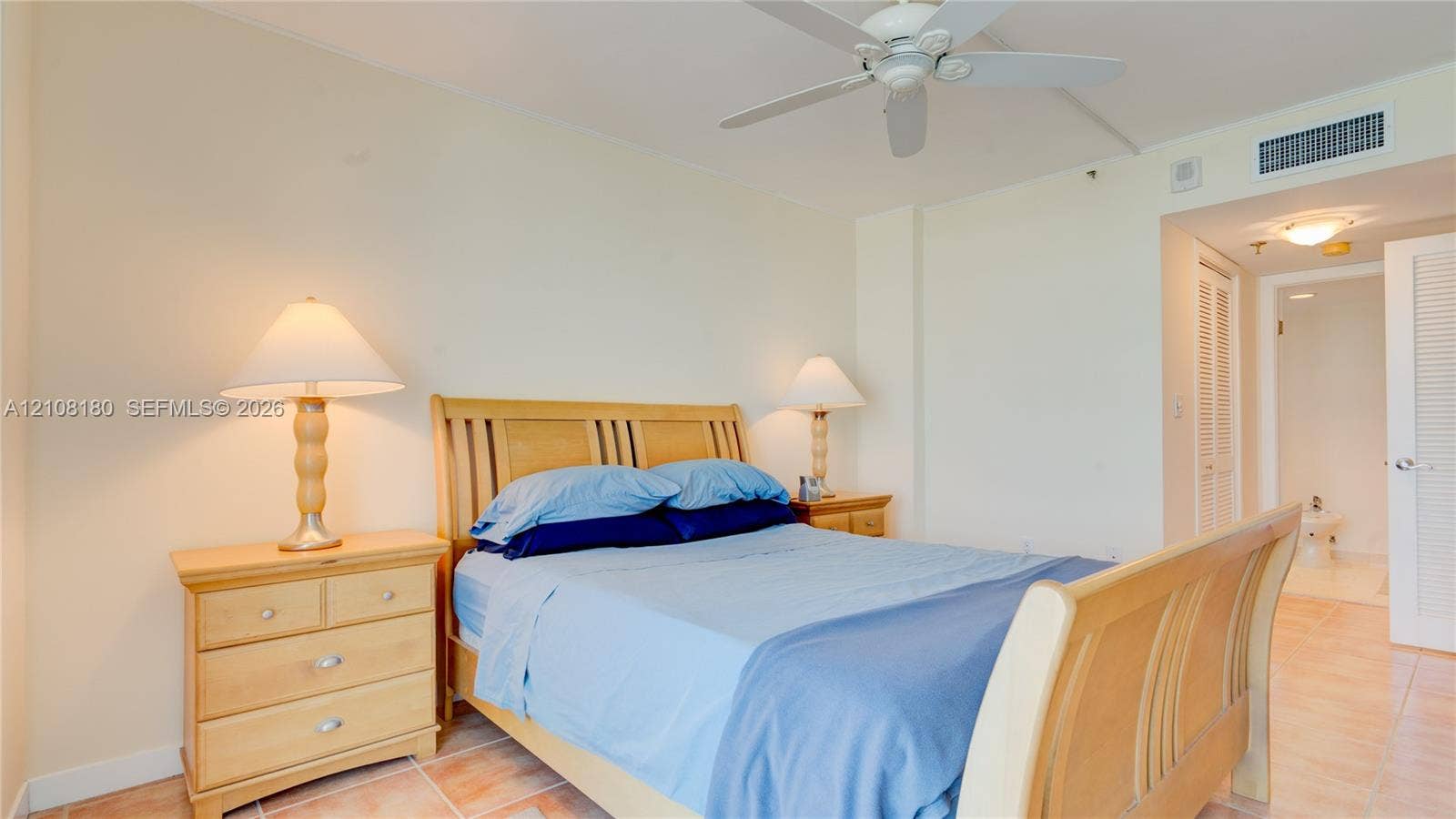 2457 Collins Avenue, #1501, Miami Beach, FL 33140 Neutral wall tones, tile flooring, and a ceiling fan with integrated lighting