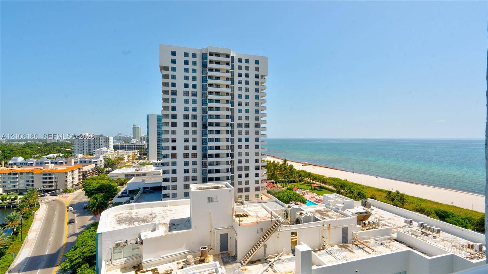 2457 Collins Avenue, #1501, Miami Beach, FL 33140 High-rise residential exterior with private balconies, featuring a coastal location with direct access to sandy beaches and open water