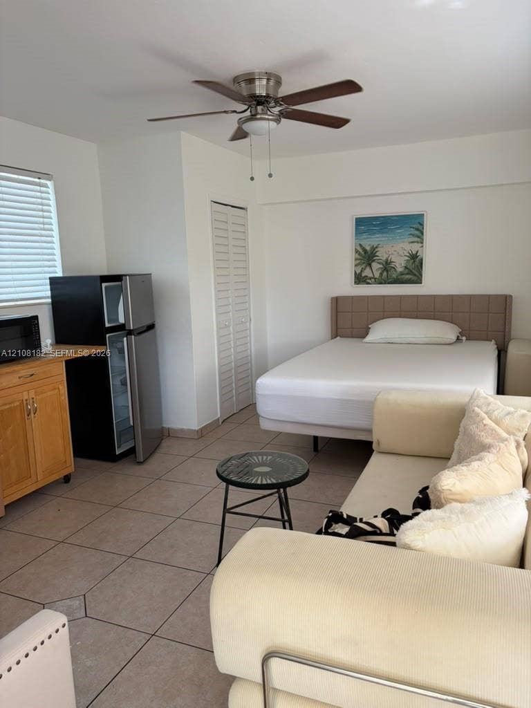 930 N 16th Avenue, #2, Hollywood, Hollywood, FL 33020 Room featuring ceramic tile flooring, built-in wooden cabinetry, louvered closet doors, and a ceiling fan