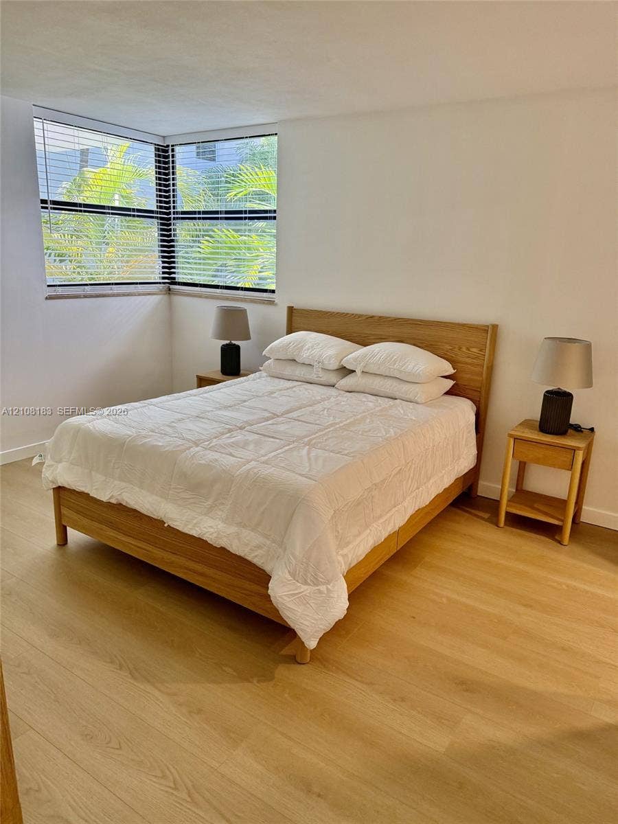 101 Ocean Lane Drive, #205, Key Biscayne, Key Biscayne, FL 33149 Corner window configuration with horizontal blinds and wood-finish flooring