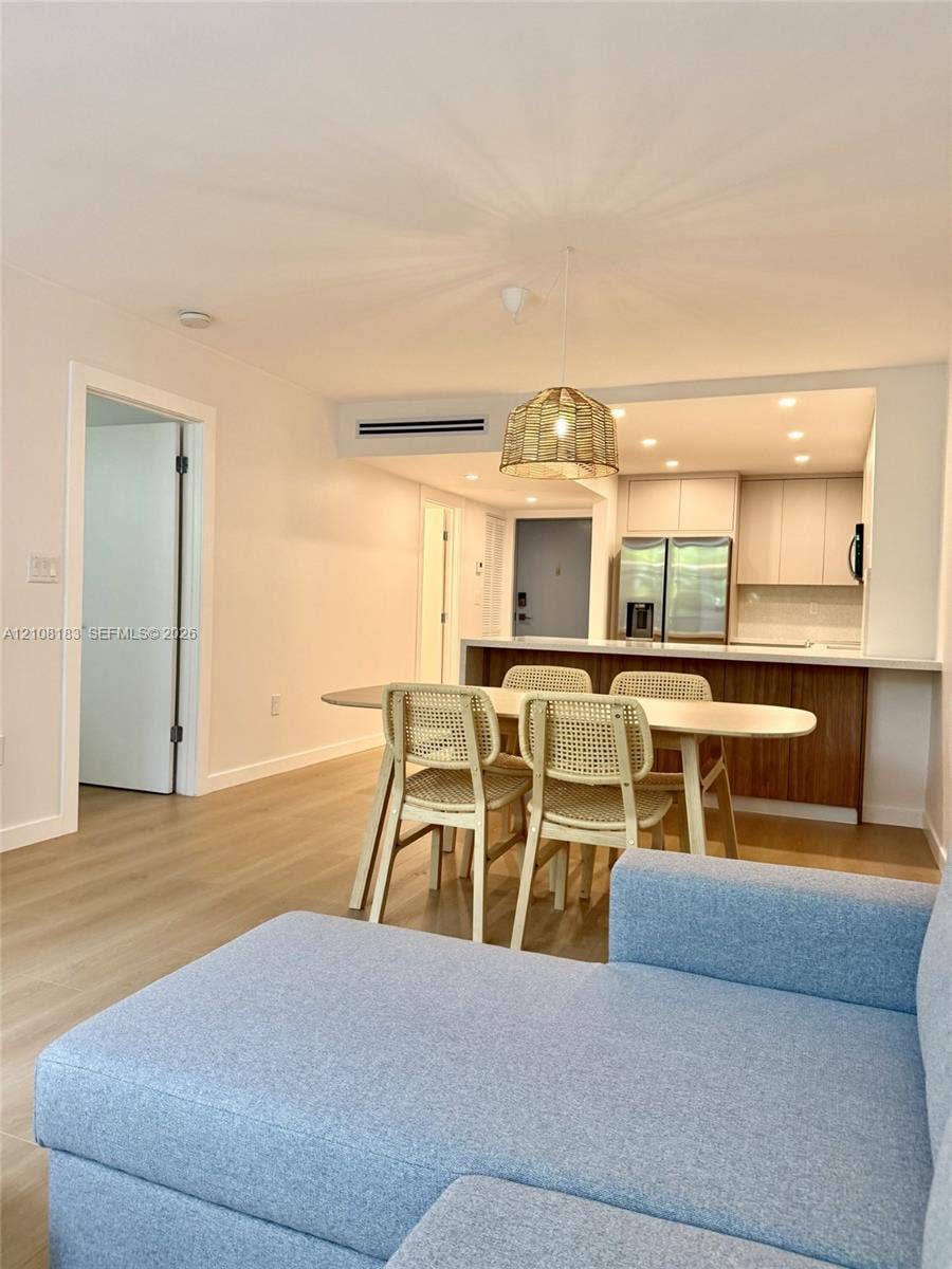 101 Ocean Lane Drive, #205, Key Biscayne, Key Biscayne, FL 33149 Open concept interior featuring light wood-finish flooring, recessed lighting, a kitchen island with white countertops, and wood-finish lower cabinetry