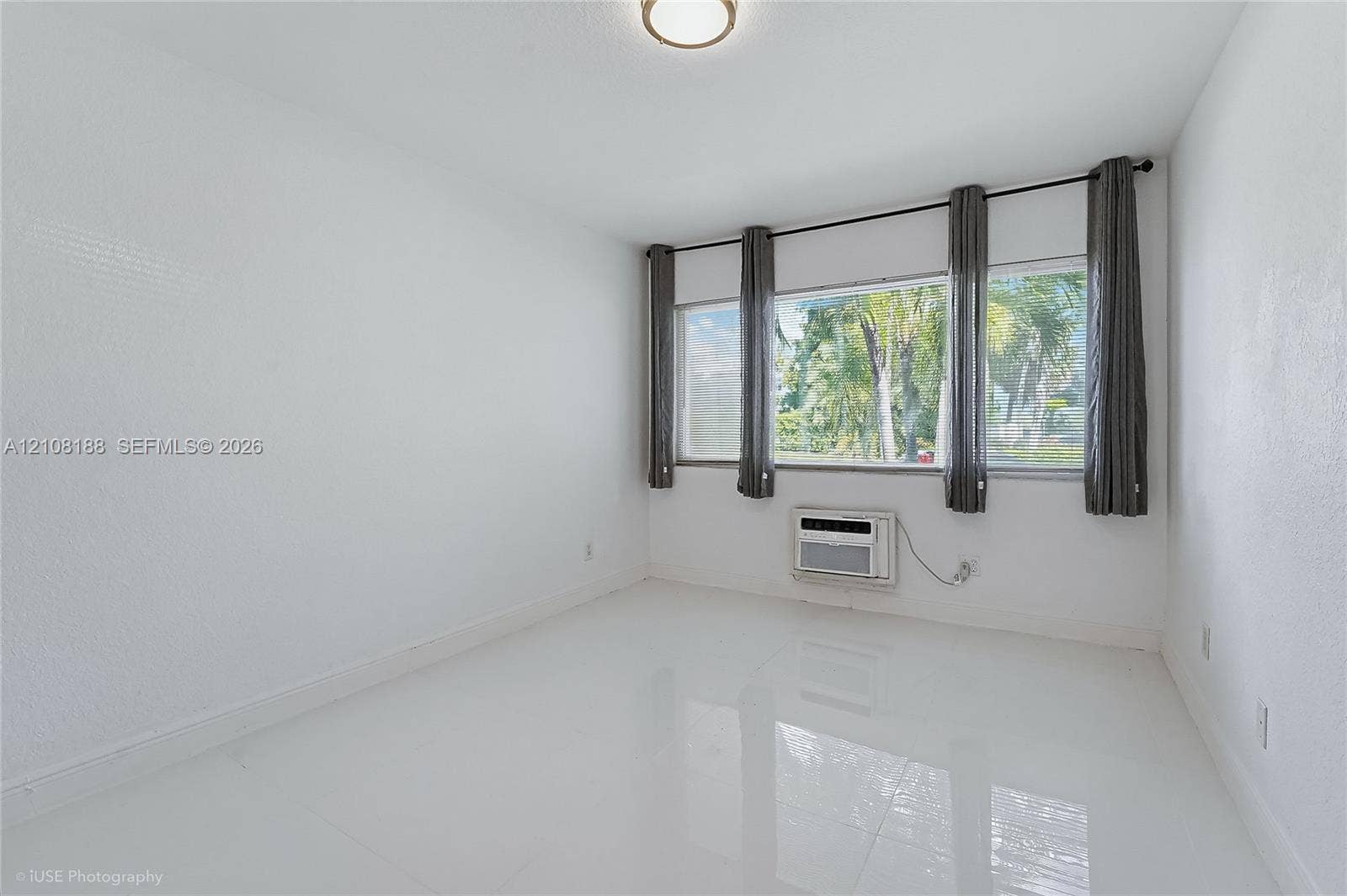 9790 E Bay Harbor Drive, #3N, Bay Harbor Islands, Bay Harbor Islands, FL 33154 Room featuring polished tile flooring, expansive triple-pane window configuration, and flush-mount ceiling lighting