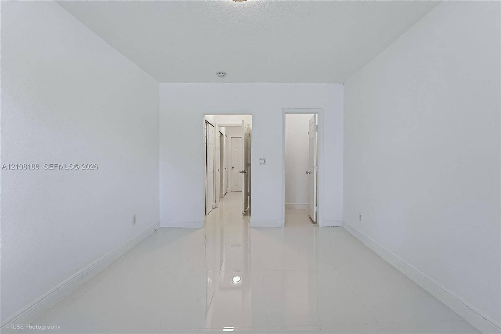 9790 E Bay Harbor Drive, #3N, Bay Harbor Islands, Bay Harbor Islands, FL 33154 Neutral interior featuring high-gloss tile flooring, smooth wall finishes, and multiple closet access points