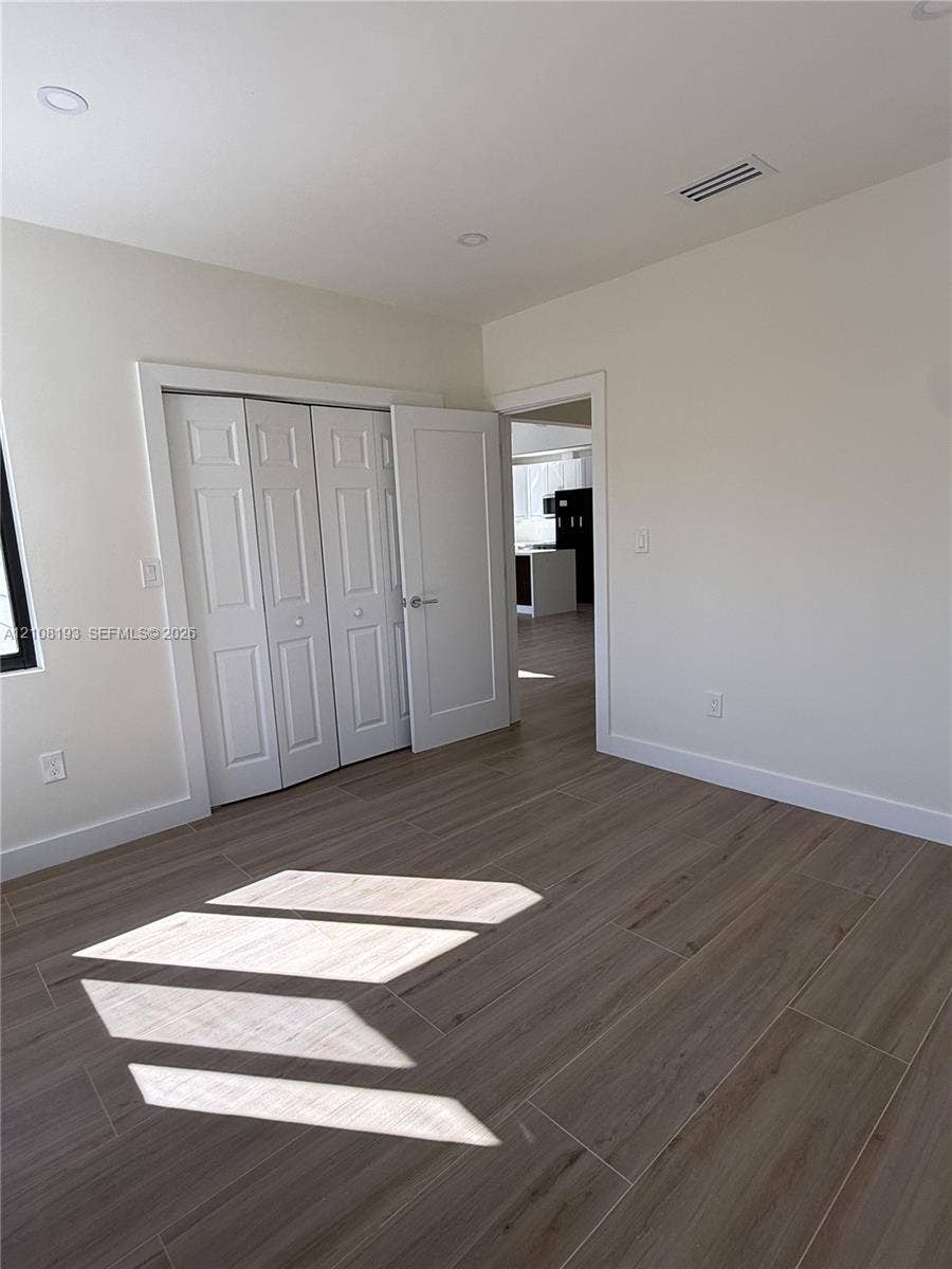 1929 SW 21st Street, #0, Miami, Miami, FL 33145 Interior space featuring wood-finish tile flooring, recessed lighting, and a multi-panel bi-fold closet door