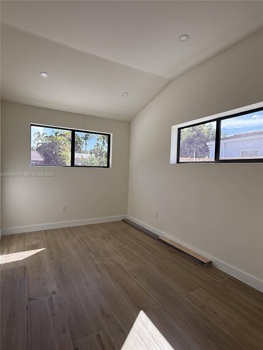 1929 SW 21st Street, #0, Miami, Miami, FL 33145 Room interior featuring wood-finish flooring, vaulted ceilings, recessed lighting, and horizontal windows with black framing