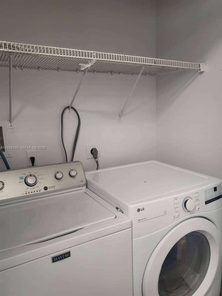 Laundry area featuring a wire-grid wall-mounted shelving unit