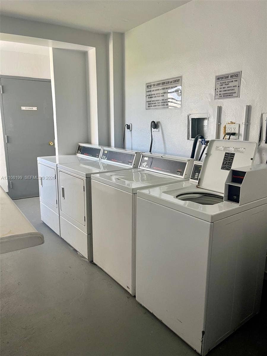 20400 W Country Club Drive, #608, Aventura, Aventura, FL 33180 Laundry facility featuring multiple top-load washers and front-load dryers, solid-surface flooring, and a grey flush-panel door