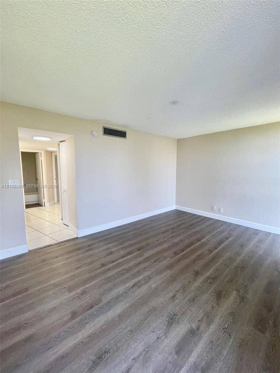 20400 W Country Club Drive, #608, Aventura, Aventura, FL 33180 Neutral-toned interior space featuring wood-finish flooring and tile flooring in the secondary area