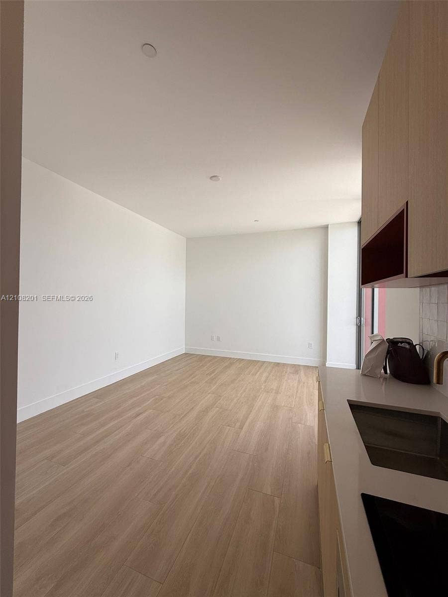 32 90 Ne 32 Street, #1115, Miami, Miami, FL 33127 Wood-finish flooring, light-toned cabinetry, solid-surface countertop, undermount sink, and recessed lighting